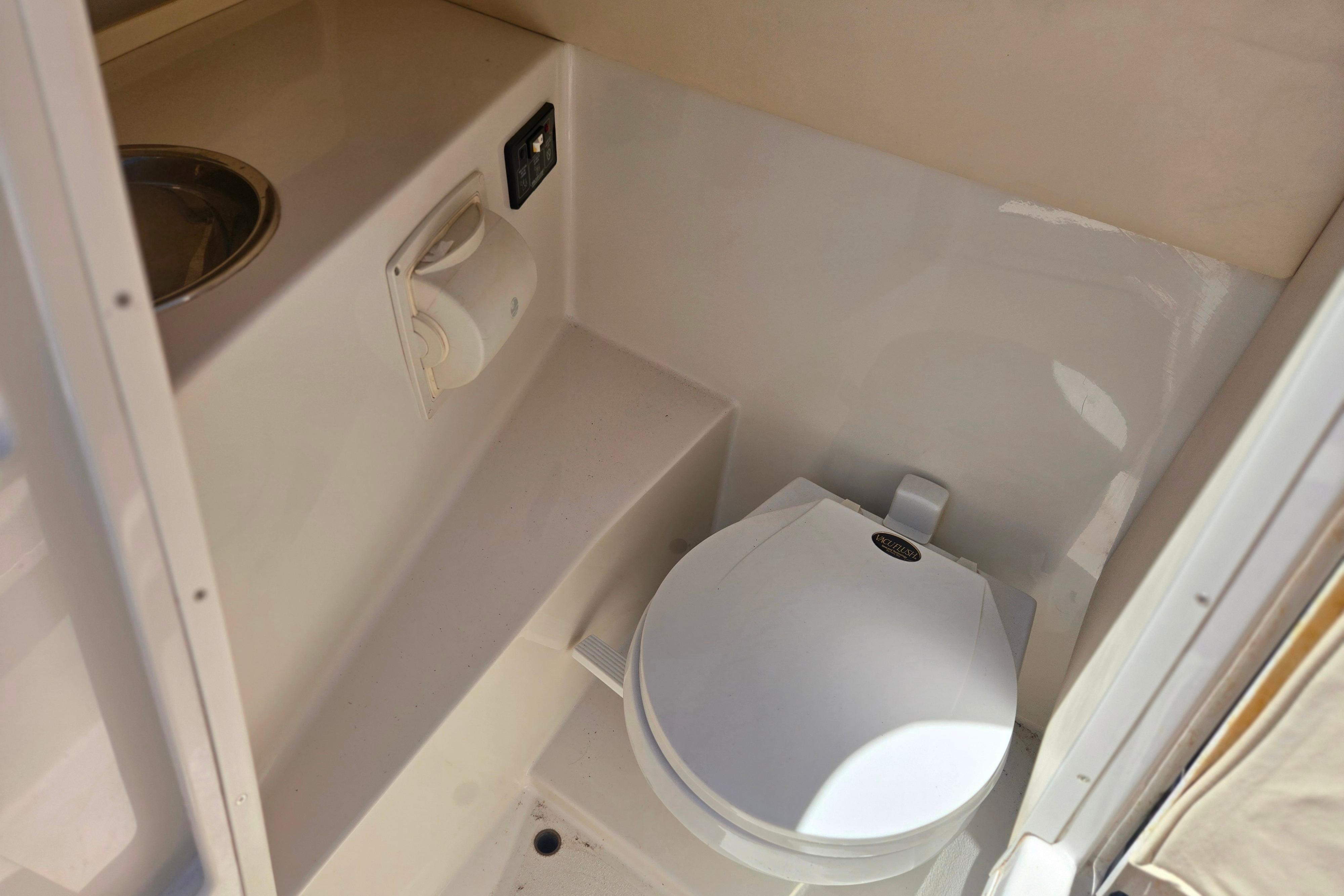 Compact marine toilet in 2002 Chris-Craft Launch 28 GT I/O boat interior.