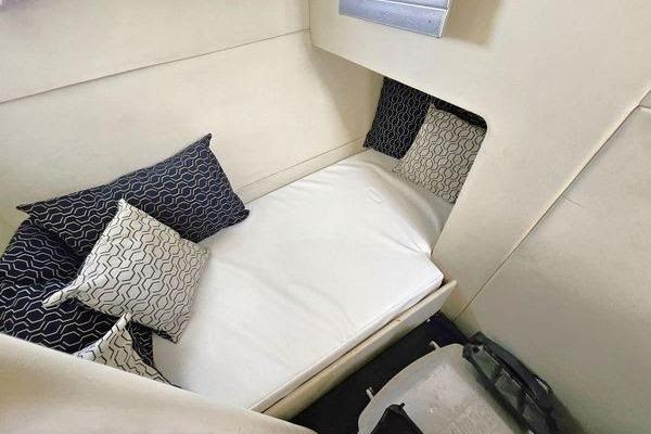 Cozy cabin interior of 2005 Sunseeker Manhattan 66 yacht with stylish pillows.