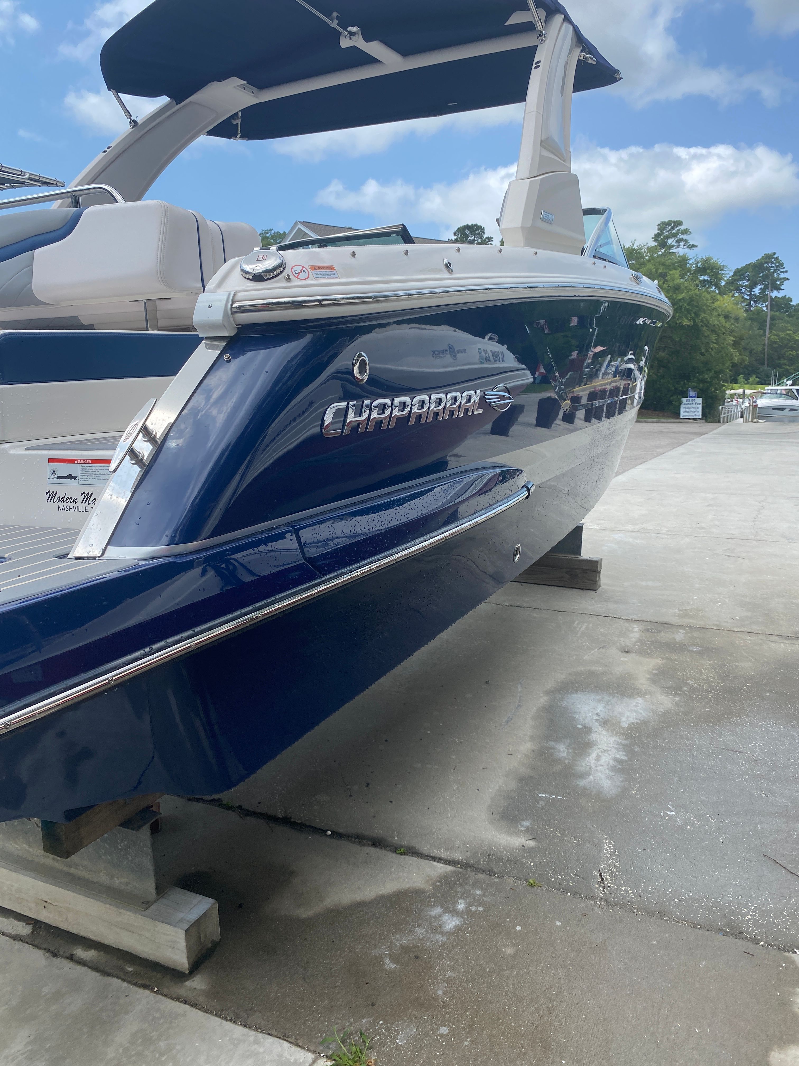 2020 Chaparral 256 SSX boat on dock, blue design.
