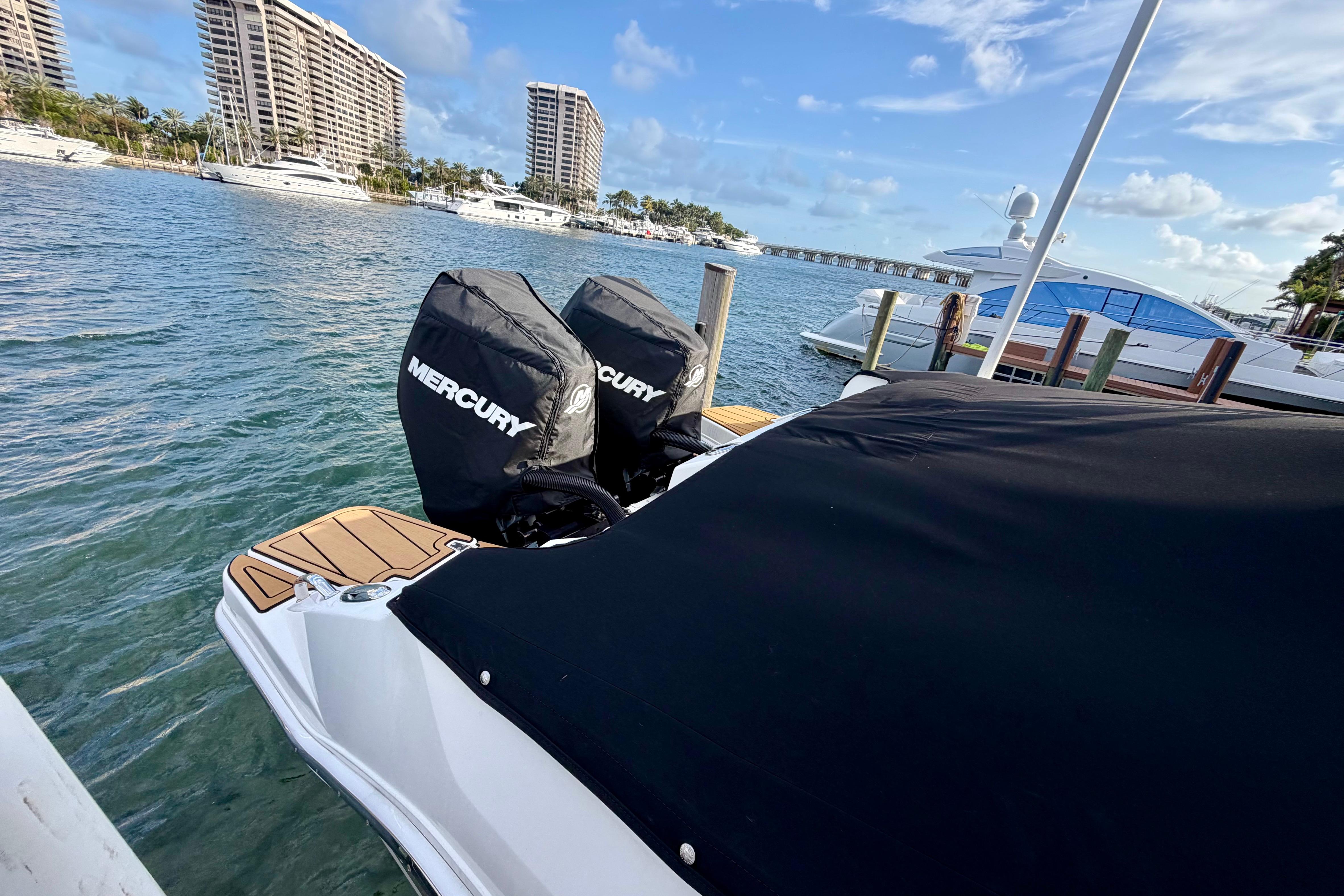 2022 Boston Whaler 280 Vantage docked with Mercury engines, scenic waterfront view.