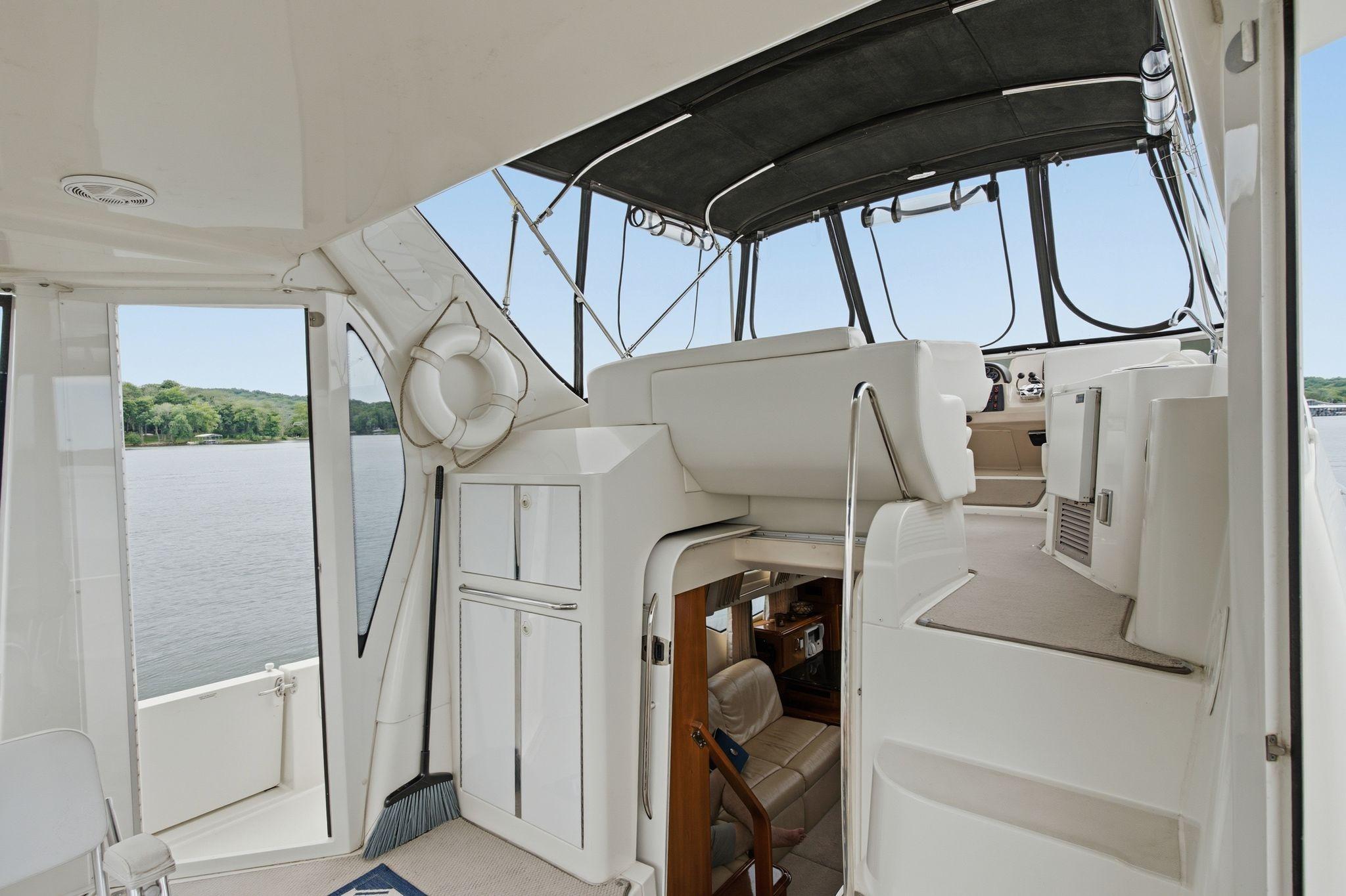 2005 Carver 39 Motor Yacht interior with helm, seating, and water view.
