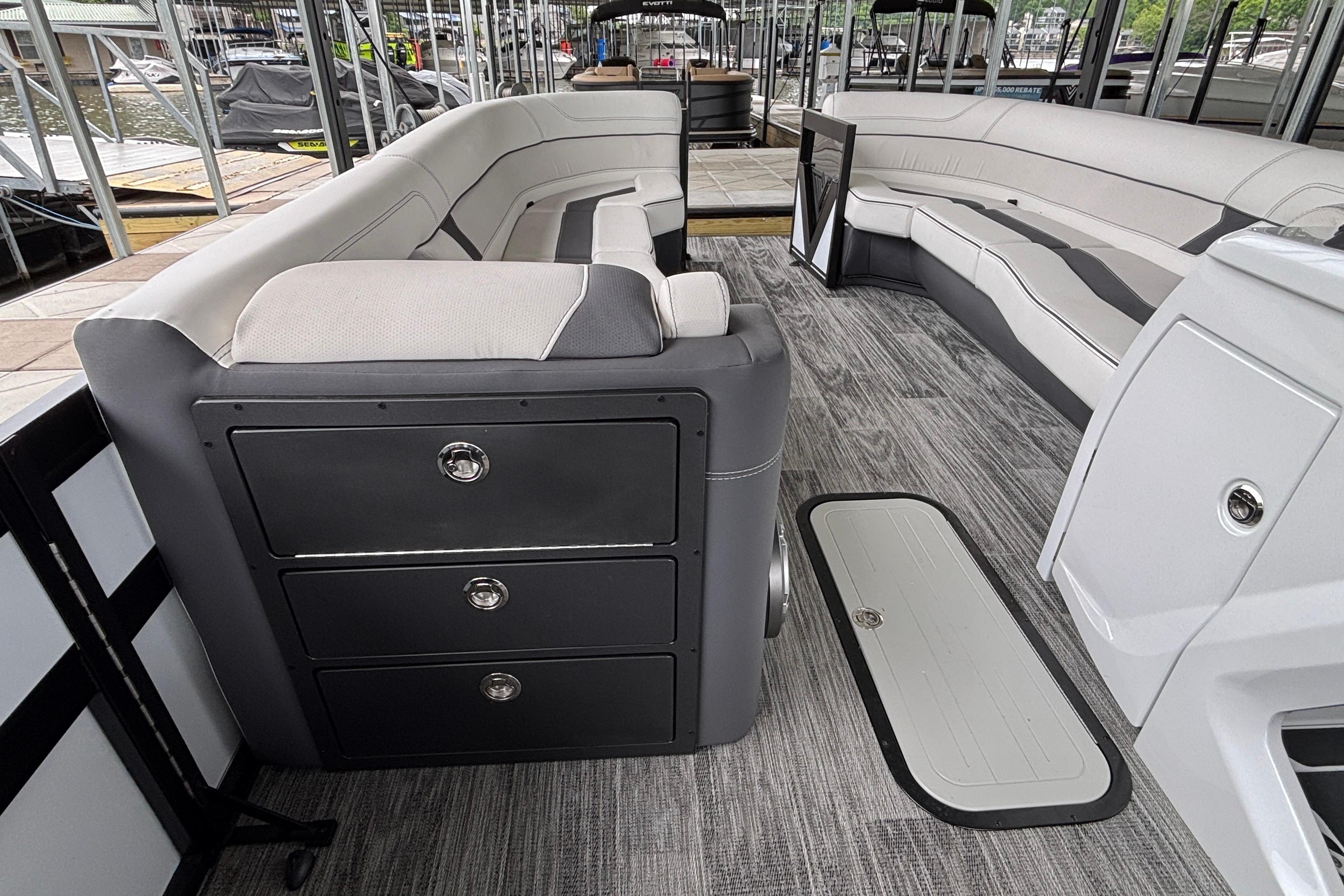 2026 Viaggio D26U boat interior with sleek seating and storage drawers at a marina.