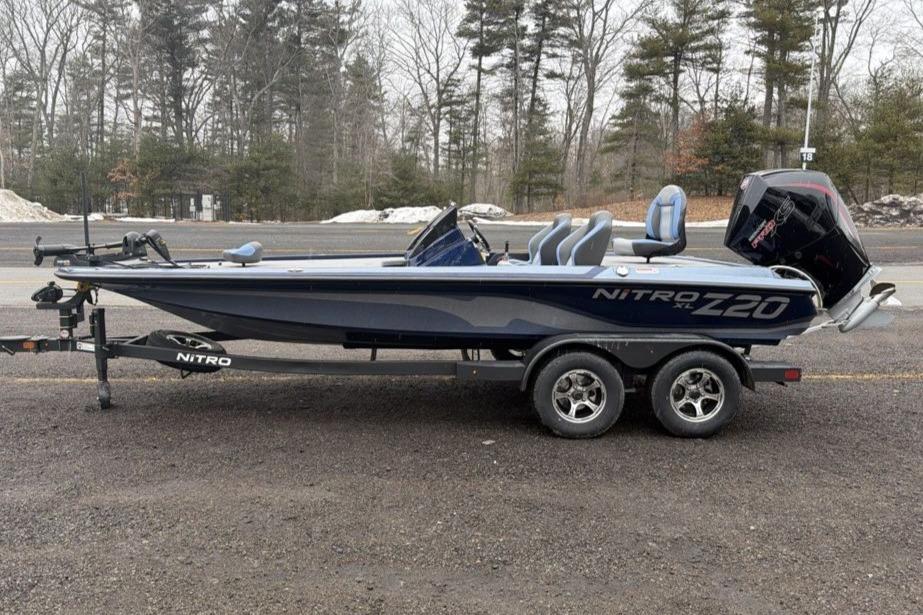 2026 Nitro Z20 XL boat on trailer, parked on roadside with forest background.