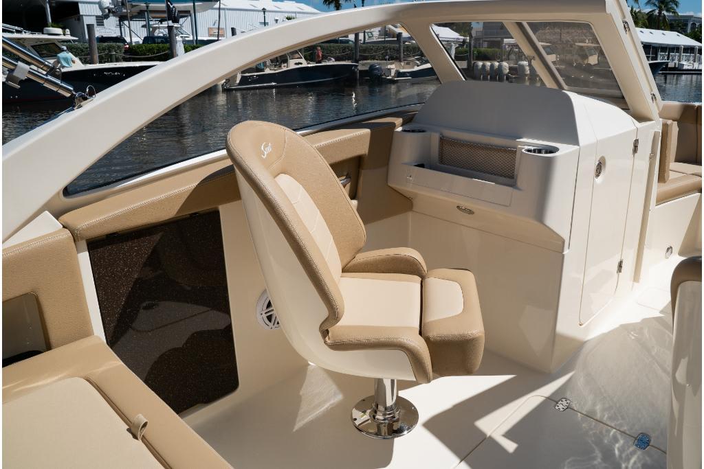 2023 Scout 240 Dorado boat interior with beige seating and helm station.