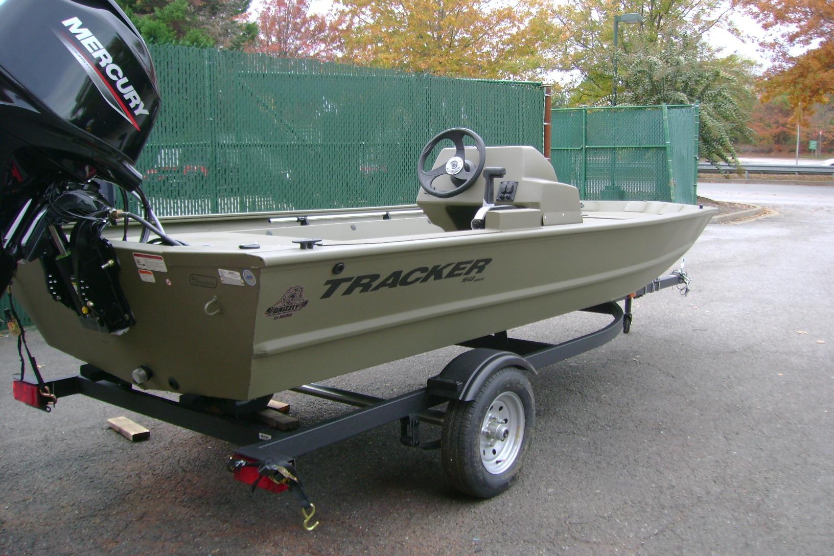 2026 Tracker Grizzly 1648 SC boat on trailer with Mercury outboard motor.