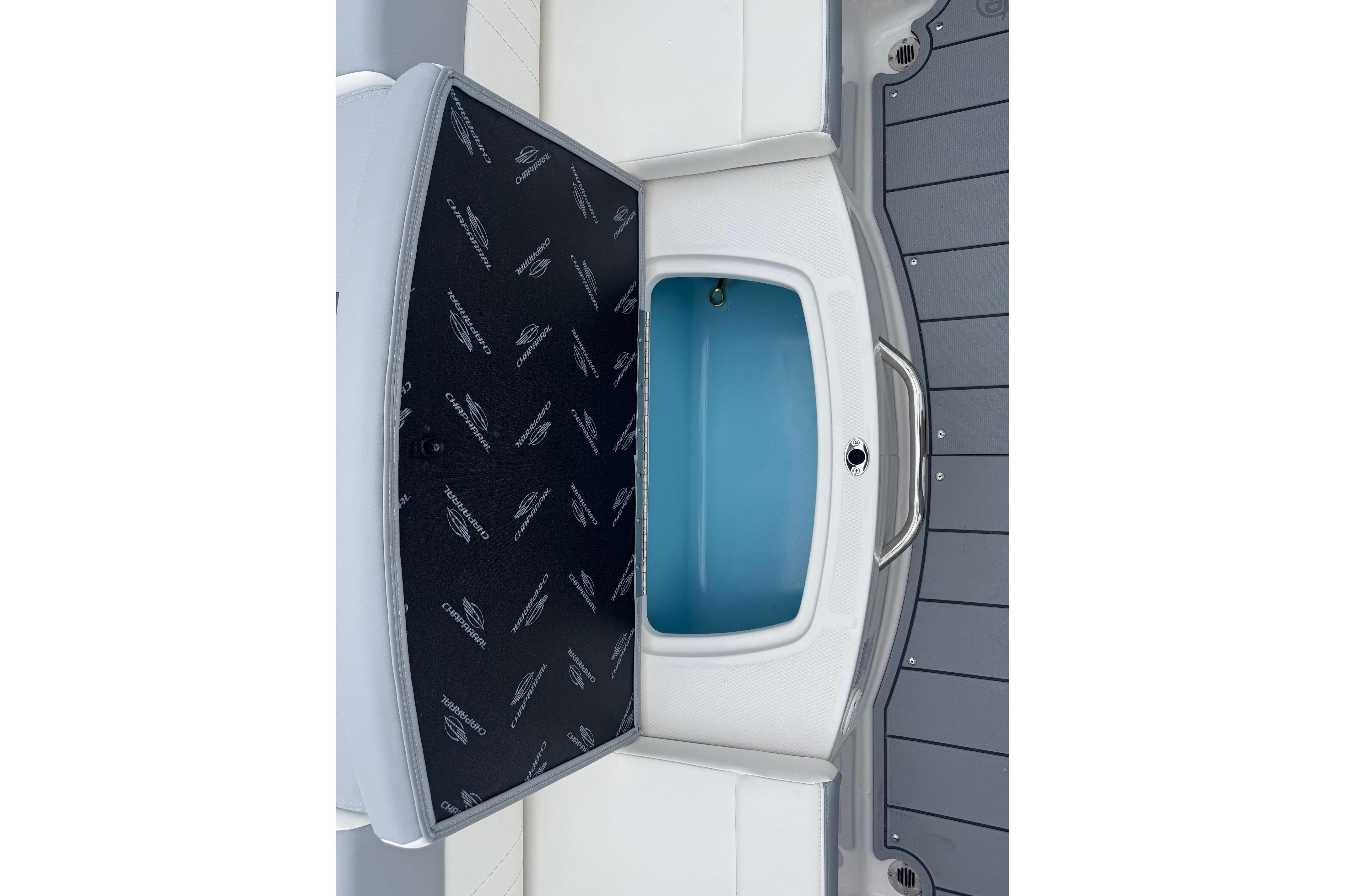 2026 Chaparral 21 SSi boat storage compartment with branded interior design.