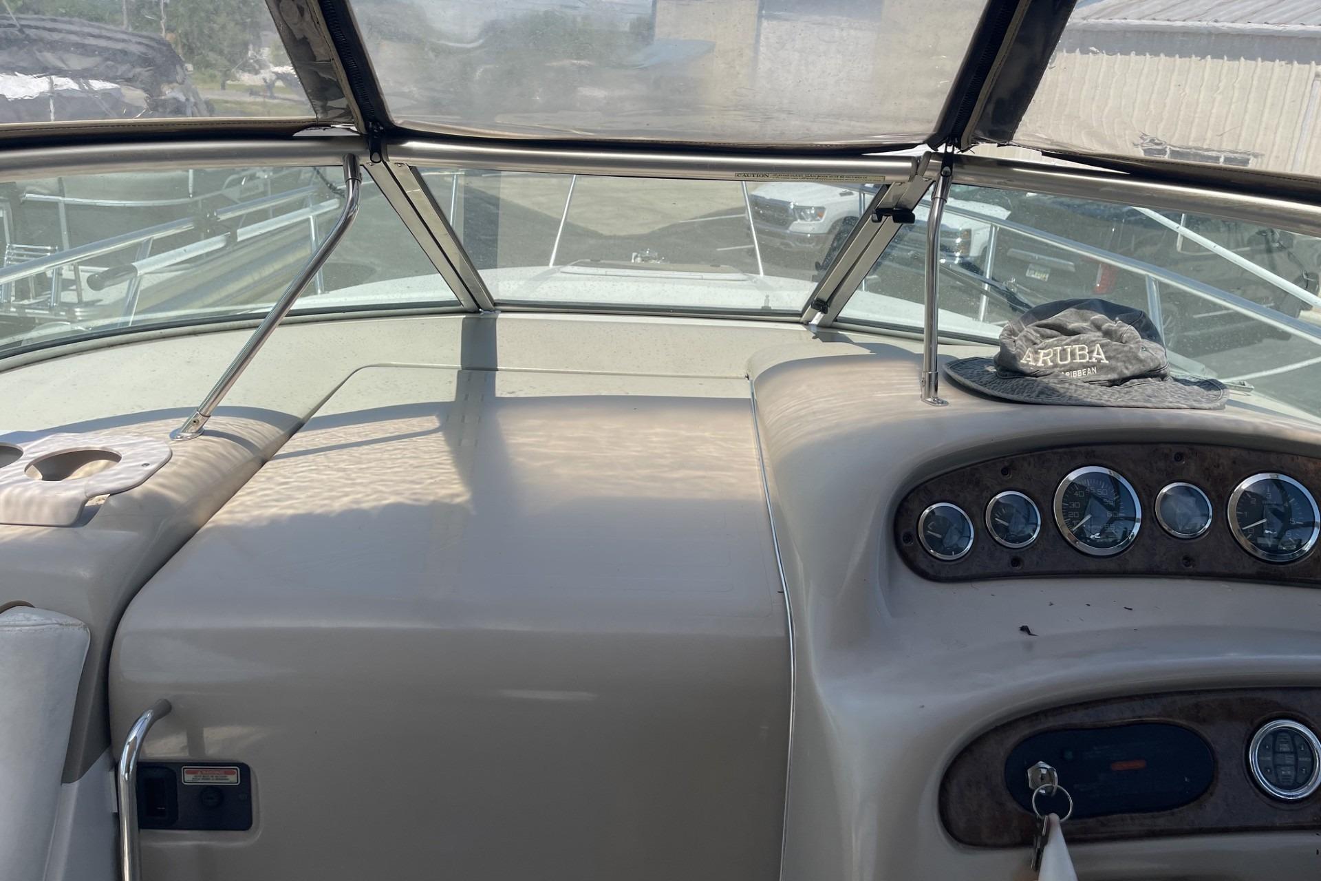 Dashboard of a 2000 Sea Ray Sundancer 260 boat with gauges and a hat.