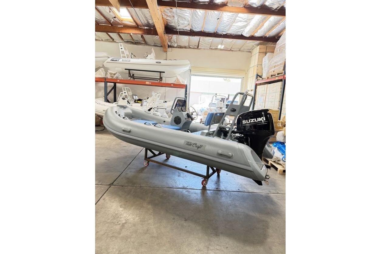 2026 Tide Craft Custom Grey and Blue Catalina 13 boat in a warehouse setting.