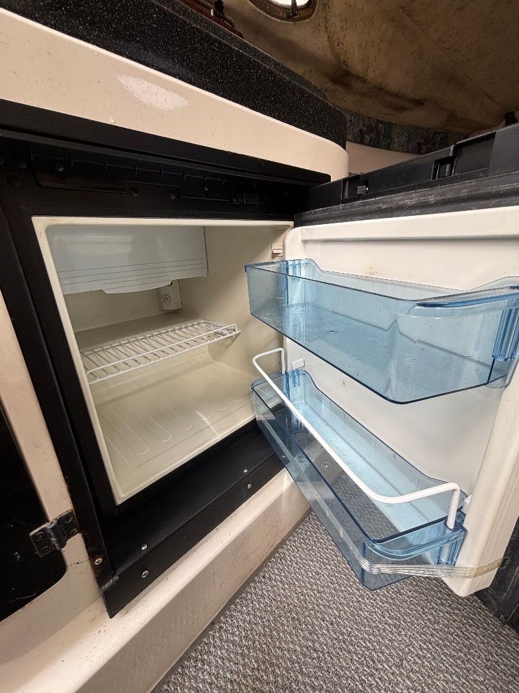 Open refrigerator on a 1997 Donzi 275LXC boat.