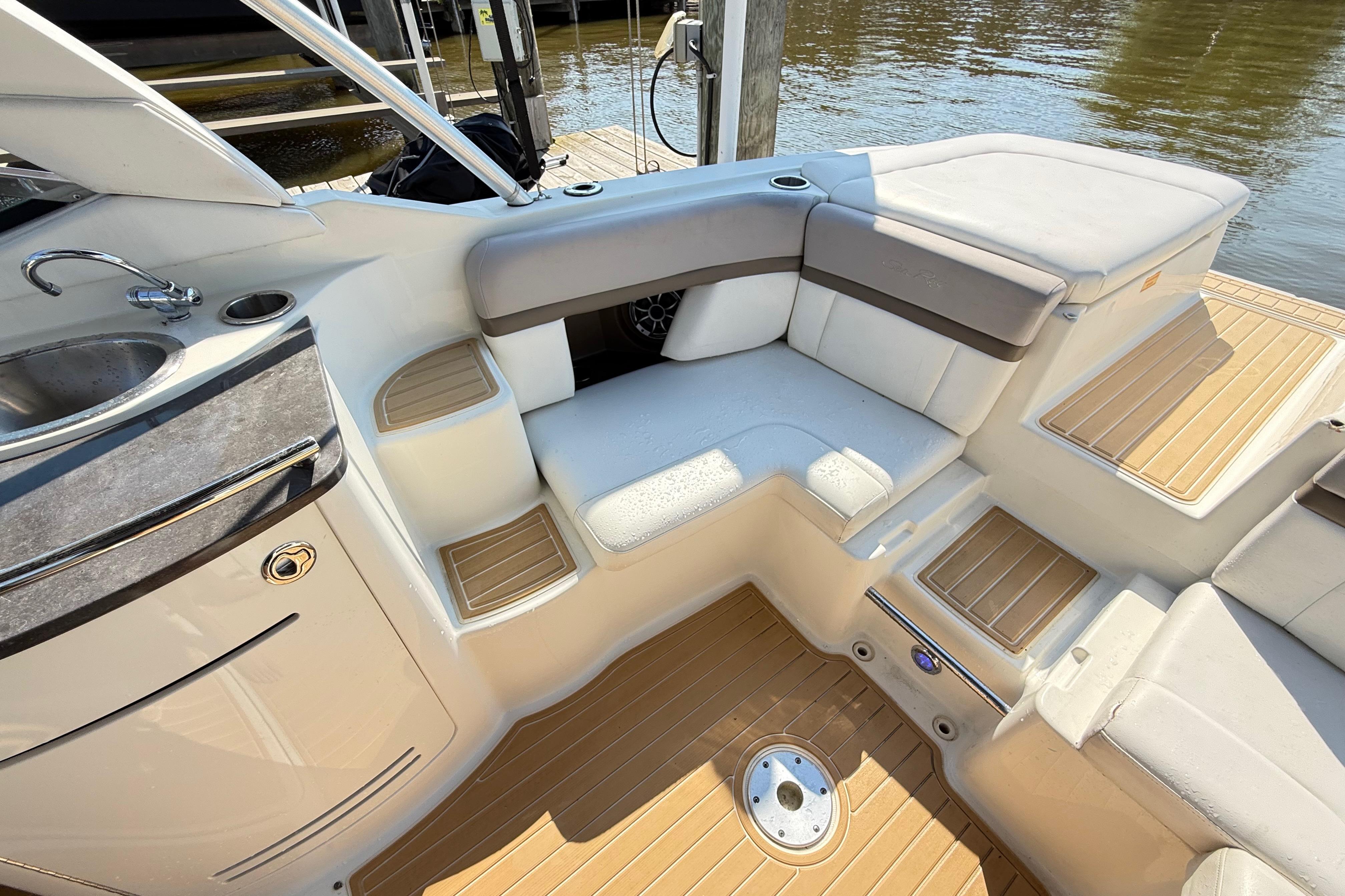 Interior of a 2011 Sea Ray 270 SLX boat with seating and sink.