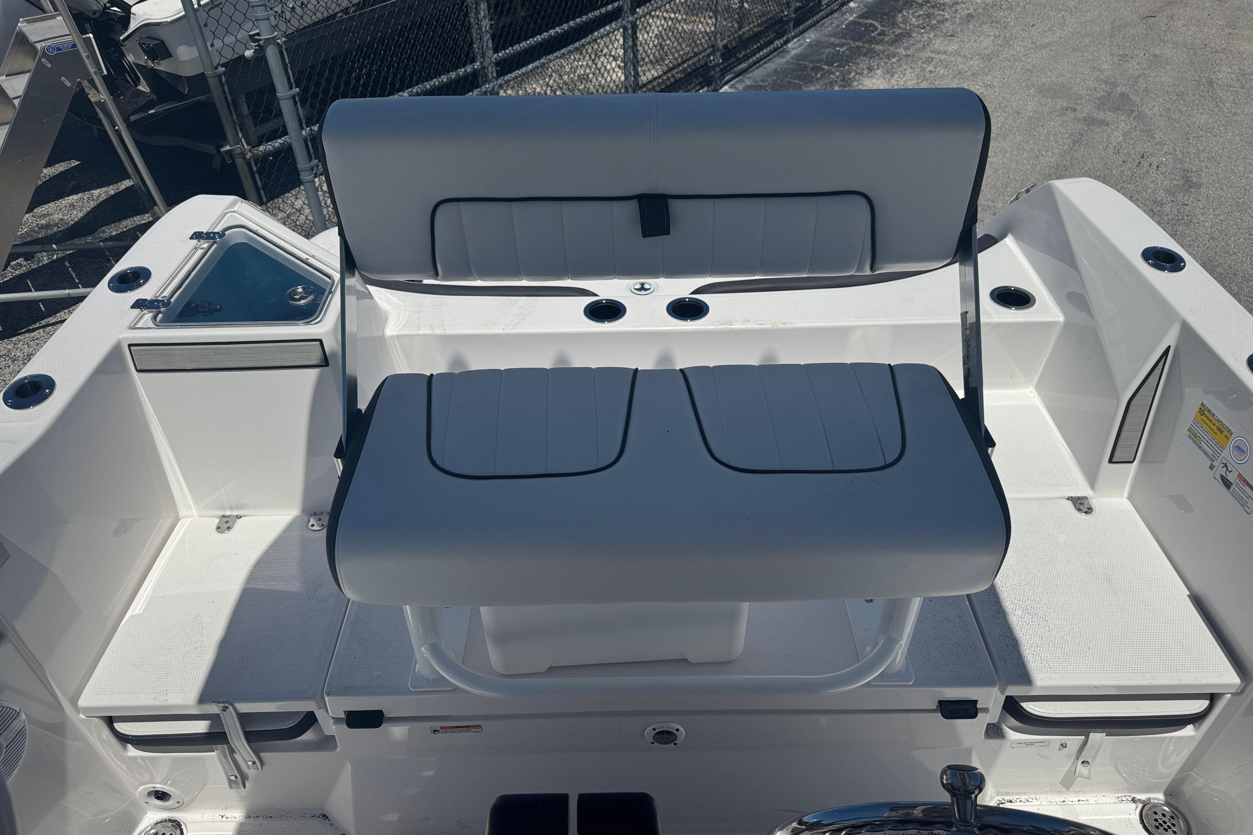 2026 Yamaha Boats 220 FSH Sport interior seating with cup holders and storage compartments.