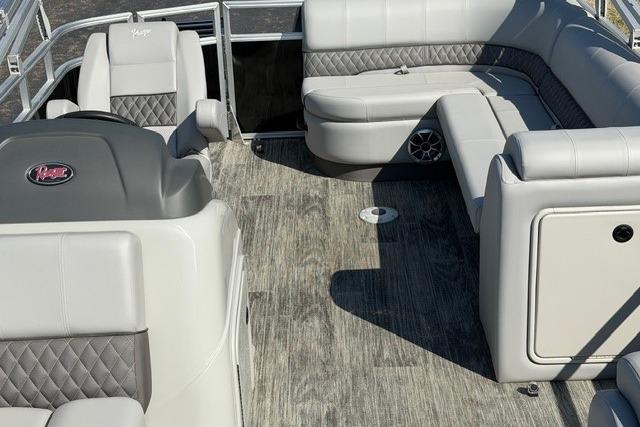 2025 Ranger Reata 223C boat interior with gray seating and wood-style flooring.