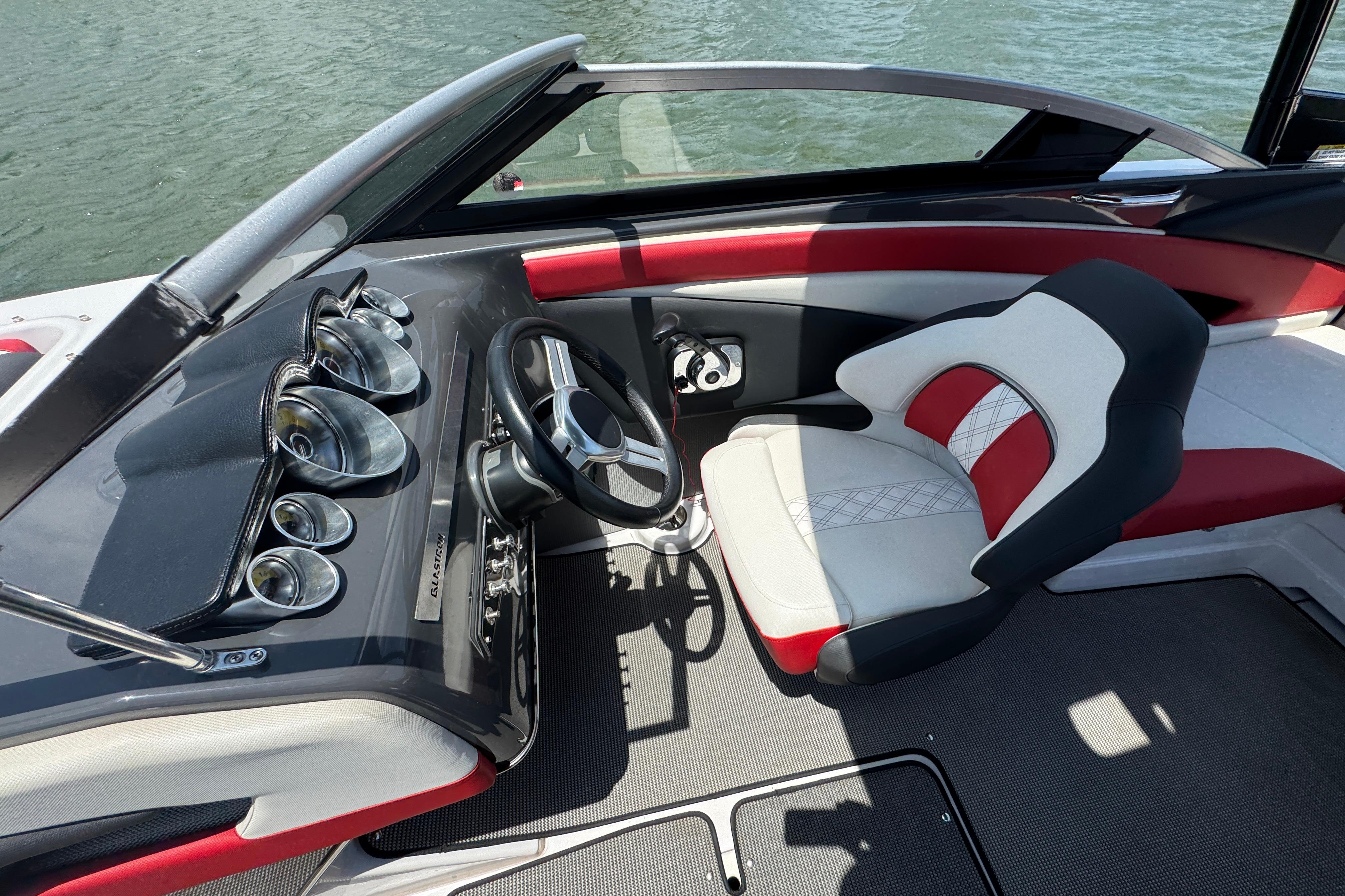 2017 Glastron GT 225 boat interior with steering wheel and stylish seating.