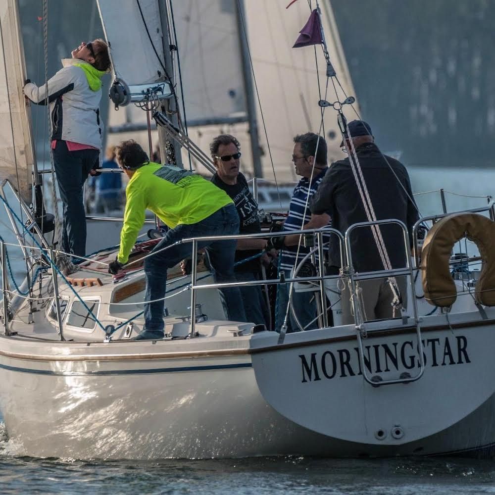 1984 Catalina 30 sailboat with crew on water.