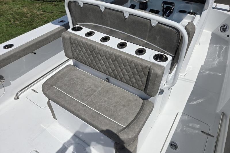 2027 Sea Hunt Ultra 275 SE boat interior with cushioned seating and cup holders.