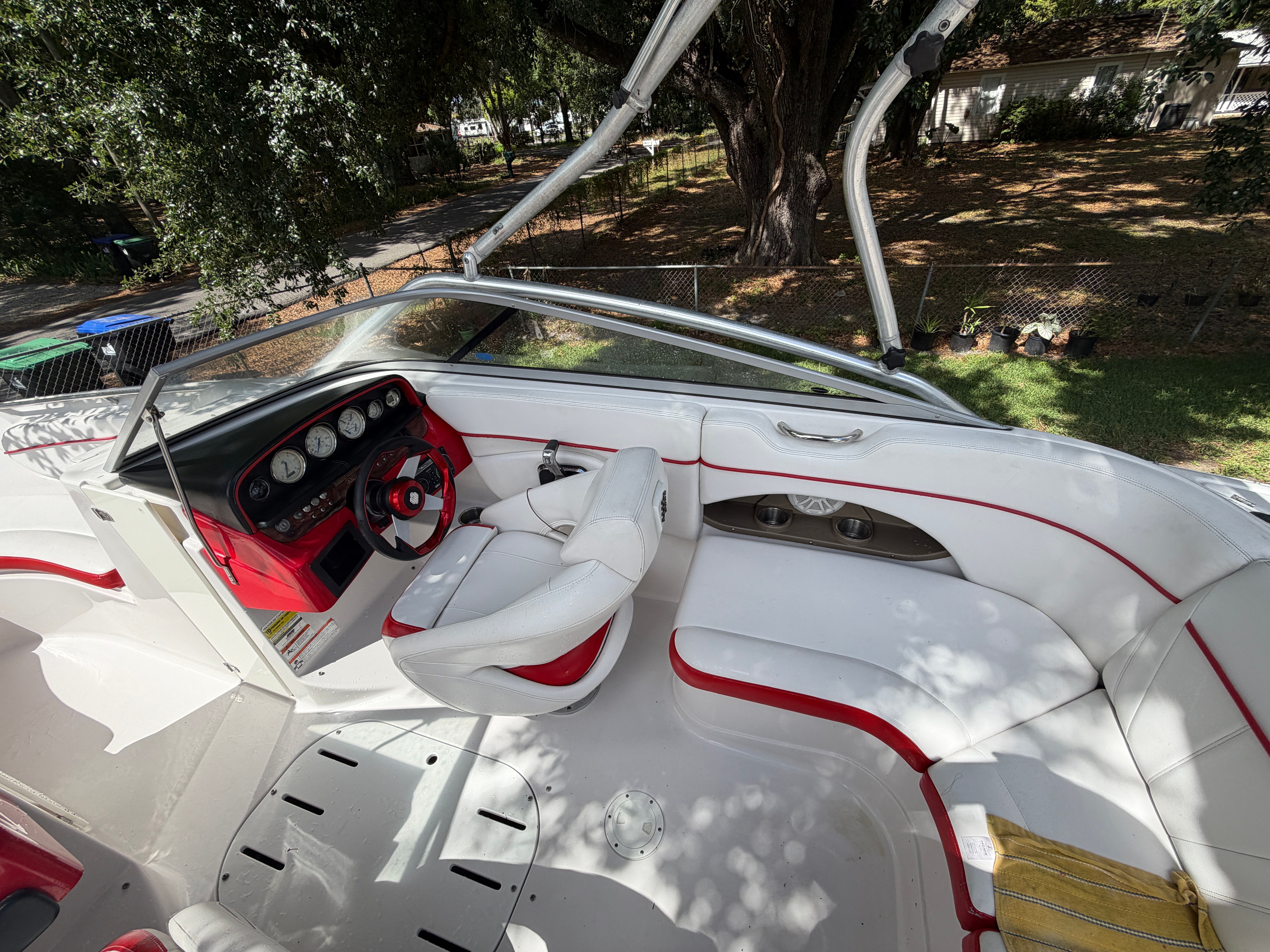 Interior of a 2009 Four Winns H220 boat with white and red seating.