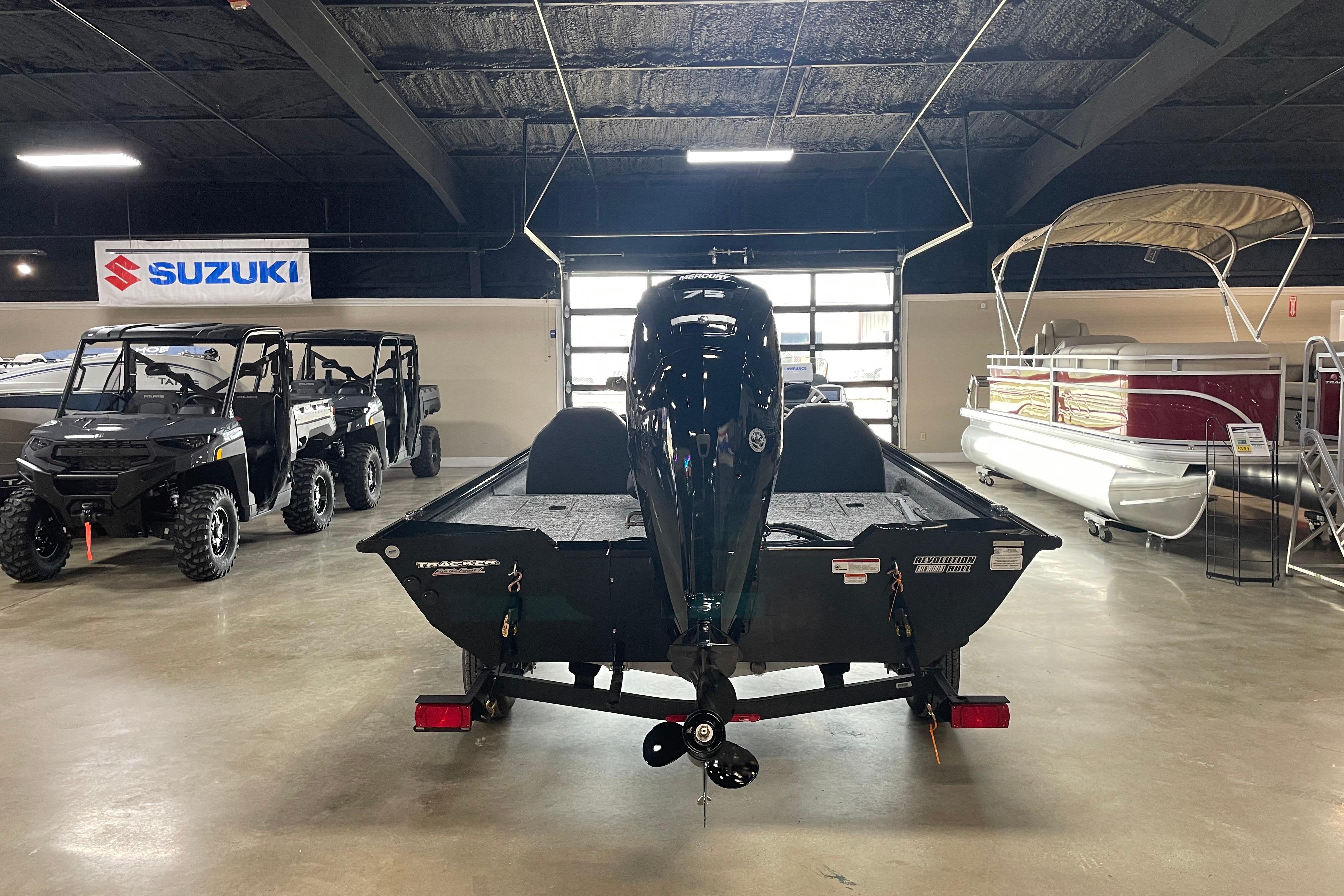 2026 Tracker Pro Team 175 Crappie Edition boat displayed in showroom with Suzuki banner.