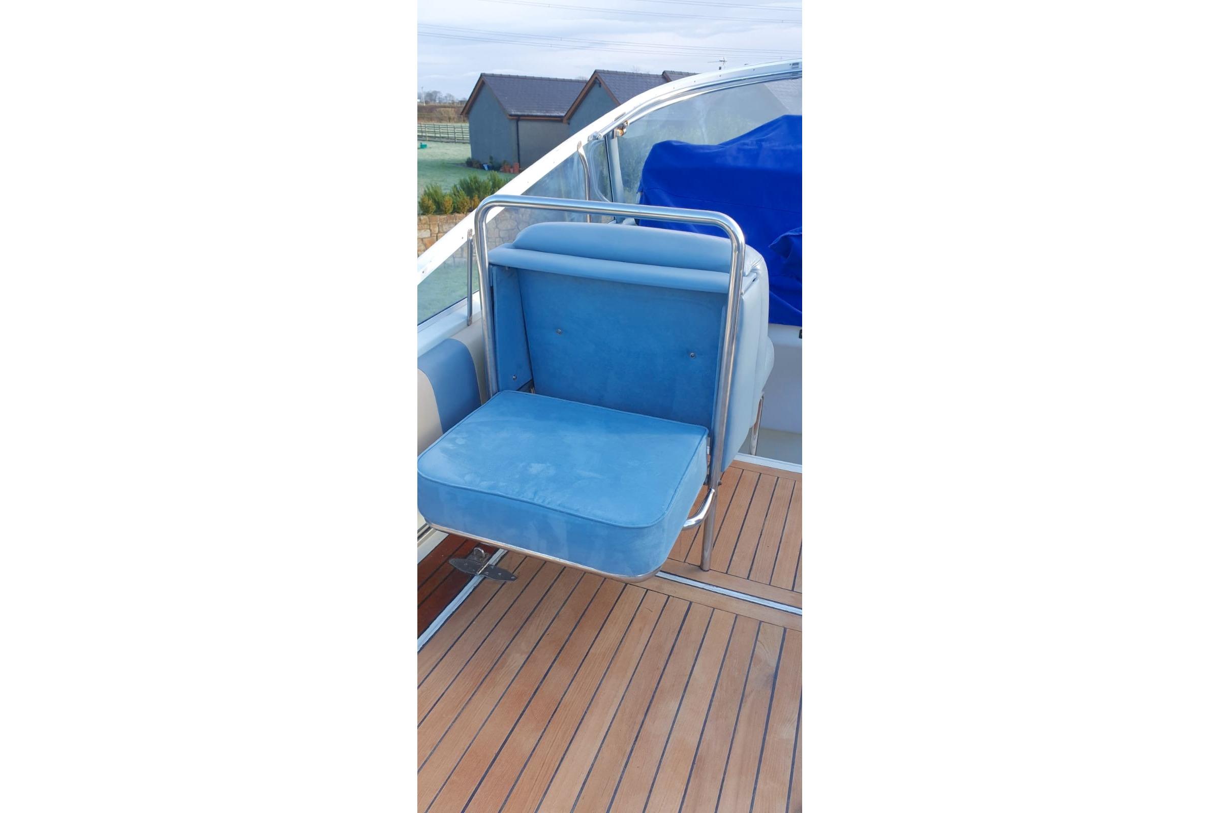 Blue seat on 1989 Fairey Spearfish MKIII boat with wooden deck.