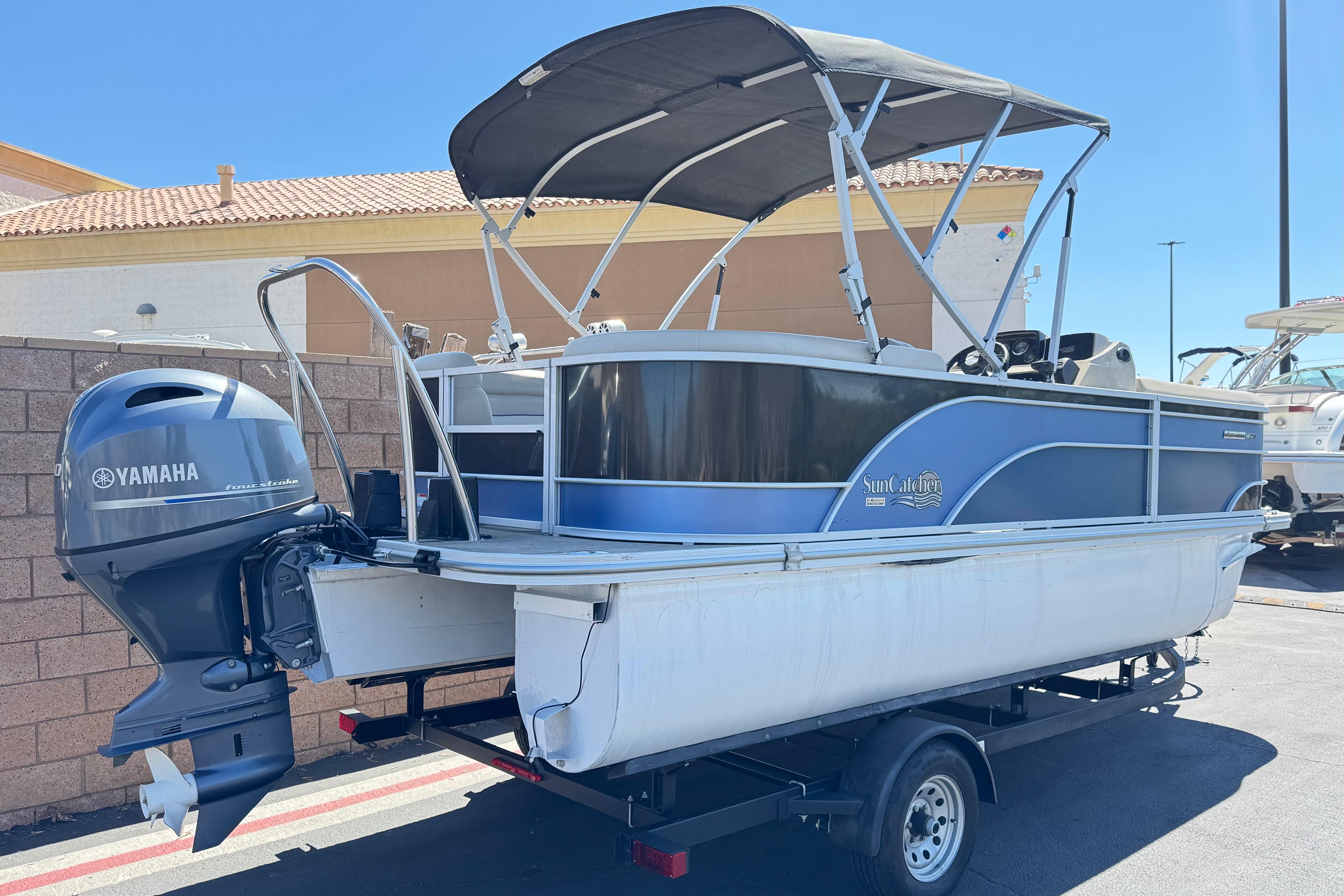 2021 SunCatcher Select 20RCX pontoon boat with Yamaha outboard motor on trailer.