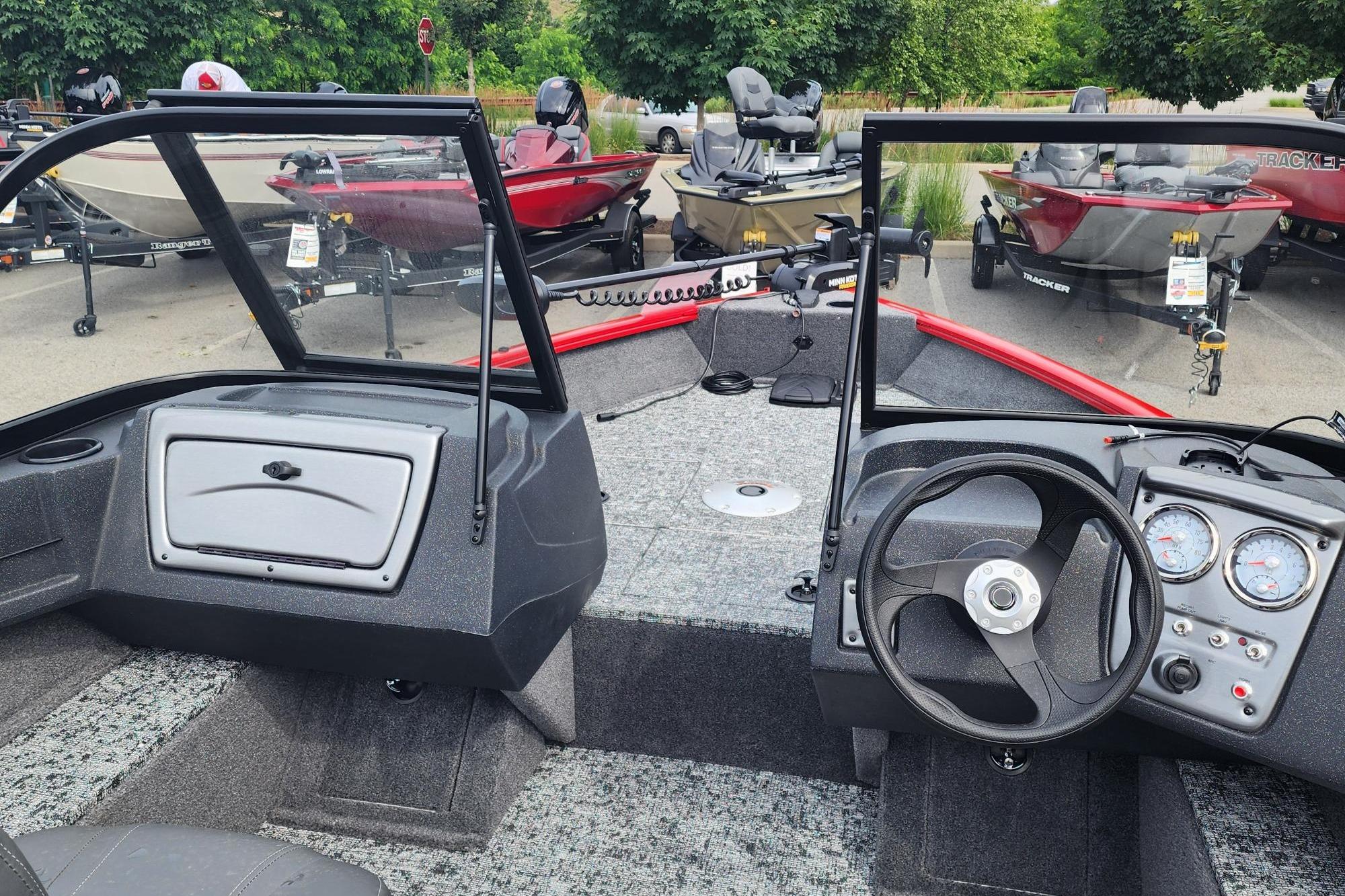 2026 Tracker Pro Guide V-16 WT boat interior with steering wheel and dashboard controls.