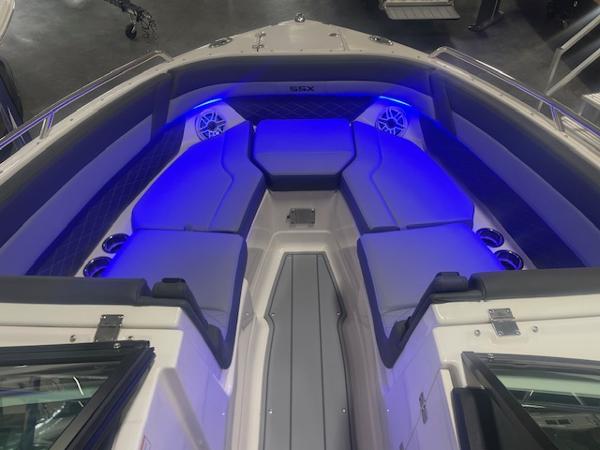 2025 Chaparral 267 SSX boat interior with blue LED lighting and cushioned seating.