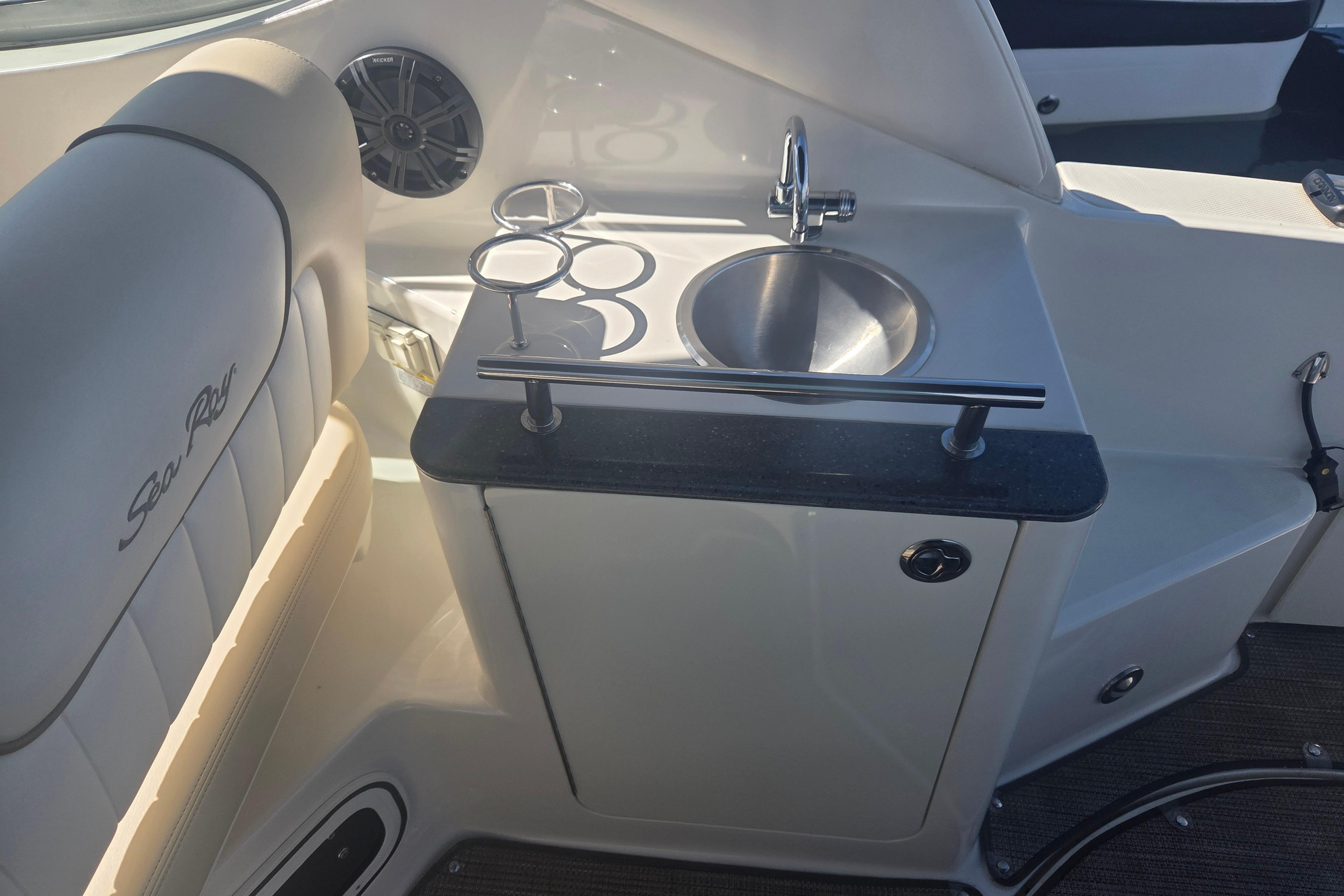 Interior of 2012 Sea Ray Sundancer 260 featuring a compact sink and seating area.