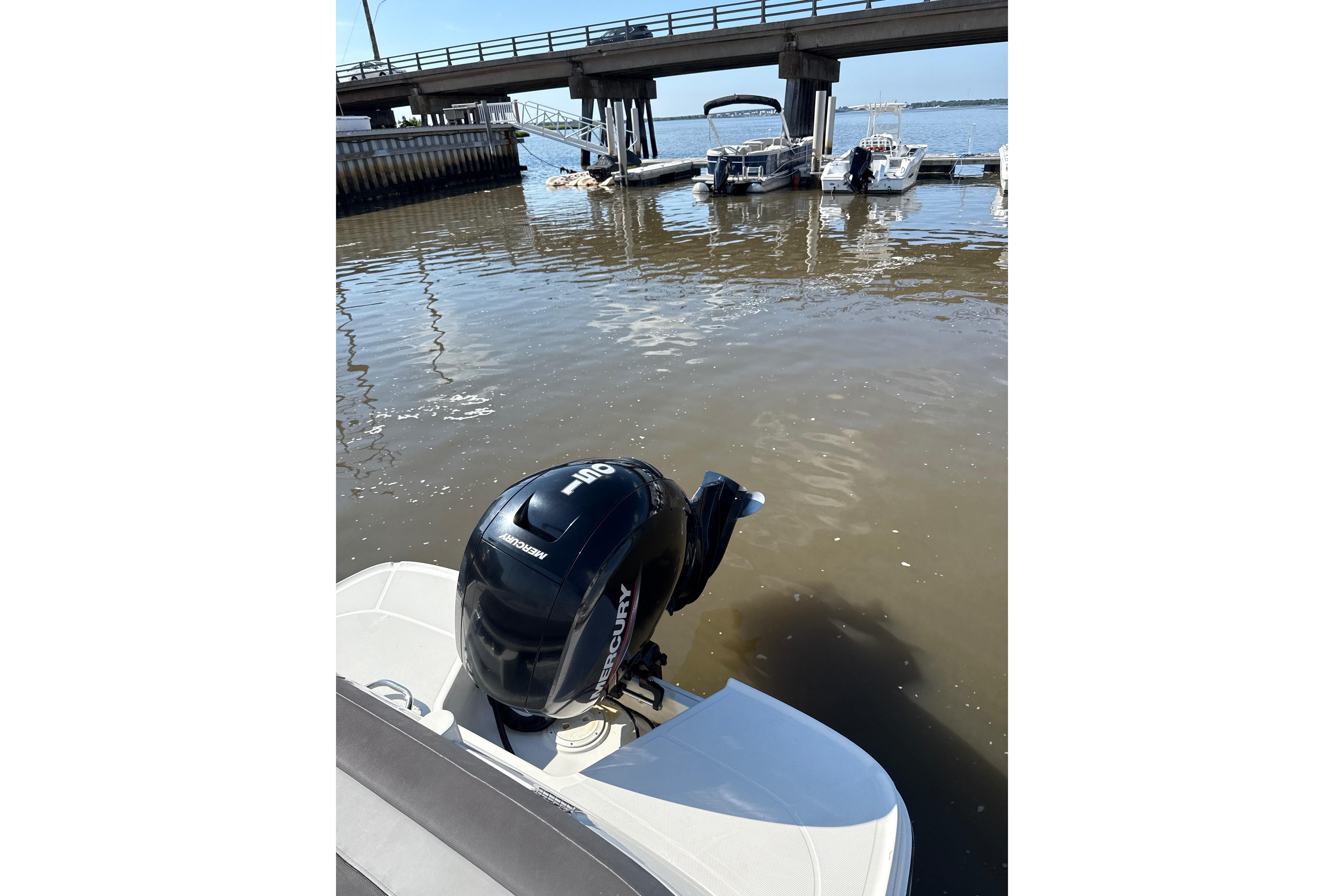 2023 Bayliner VR6 Bowrider OB with Mercury outboard engine at a dock.