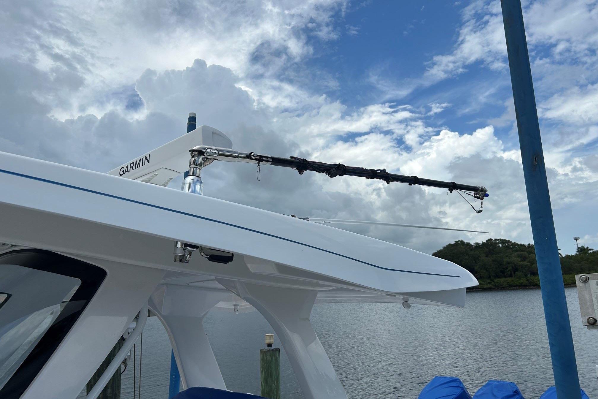 2025 Intrepid 375 Nomad SE boat with Garmin equipment, docked under cloudy sky.