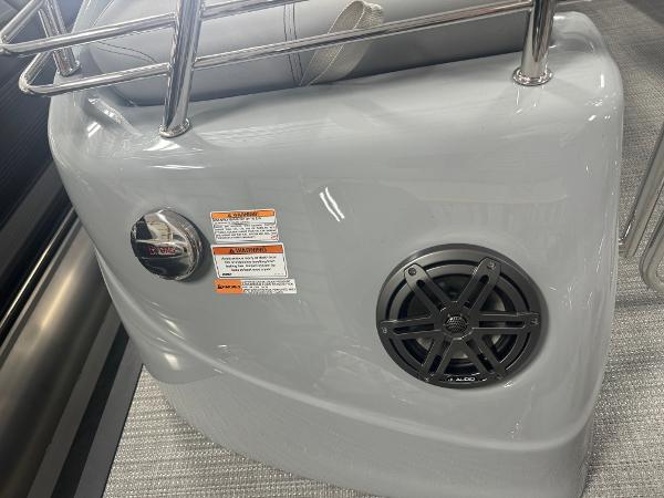 2025 Manitou LX boat interior with speaker and safety labels.
