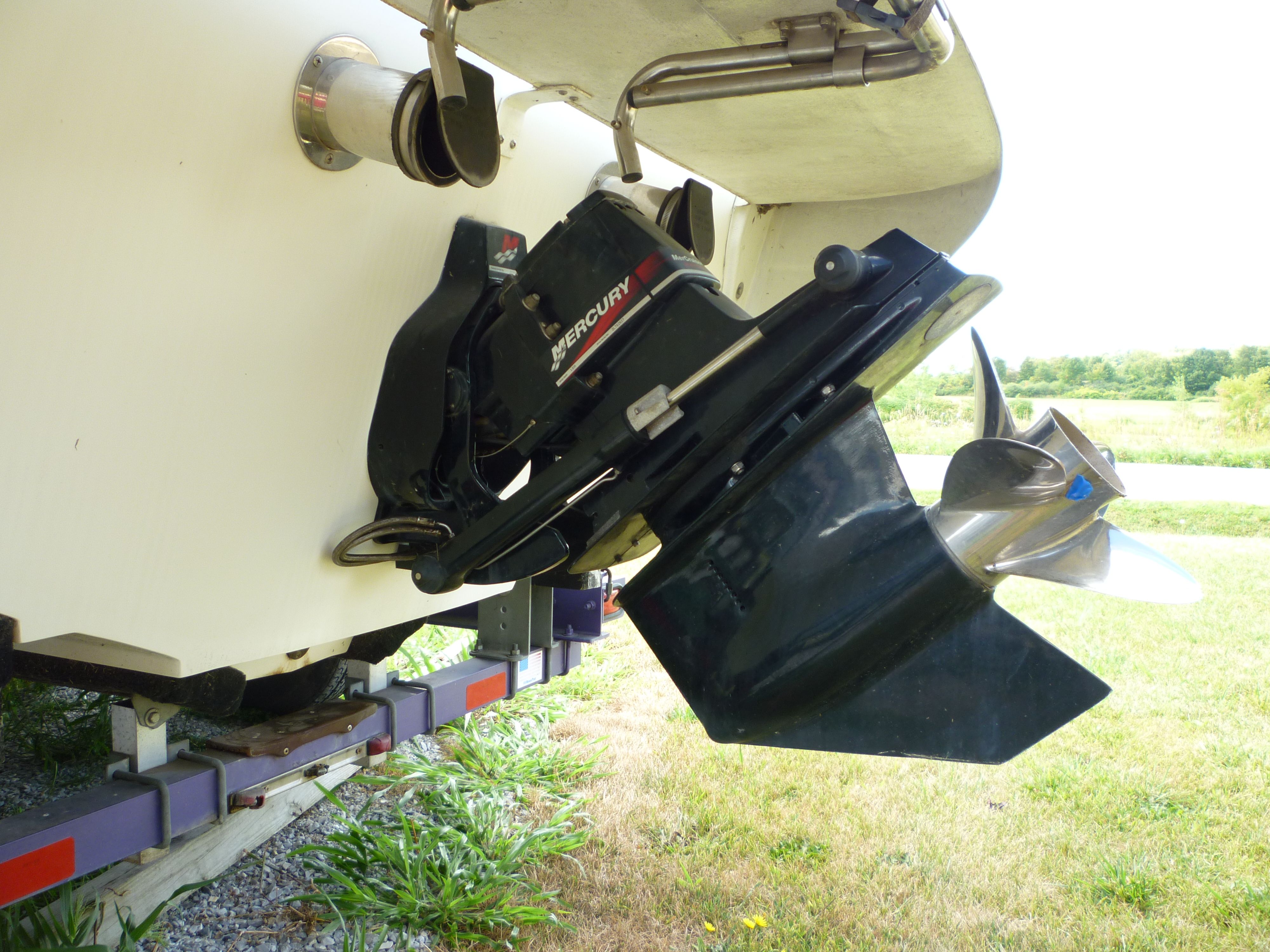 Rear view of a 2000 Velocity 280 boat with Mercury outboard motor.