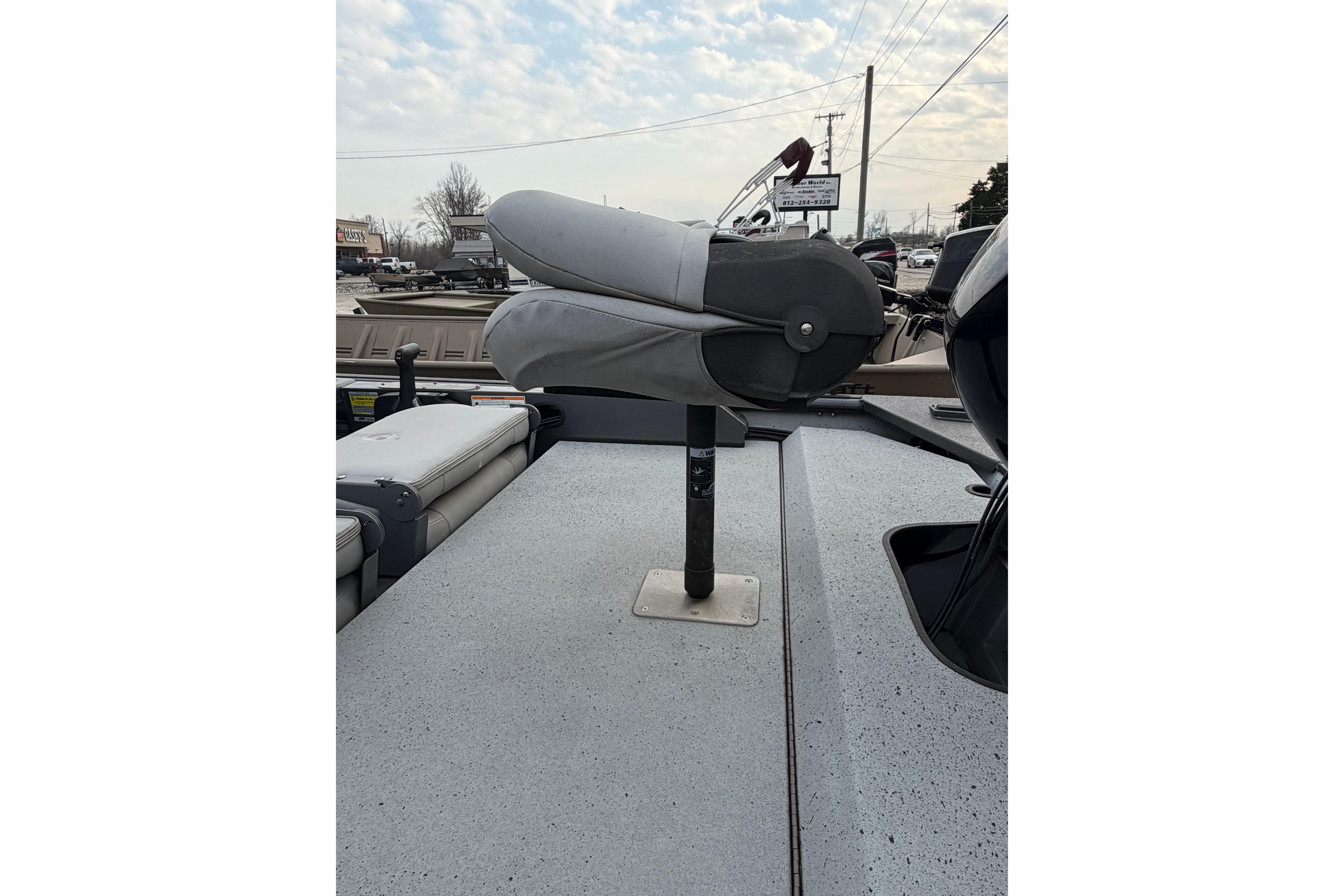 2023 SeaArk 180 RX boat with folded seat on deck, under cloudy sky.