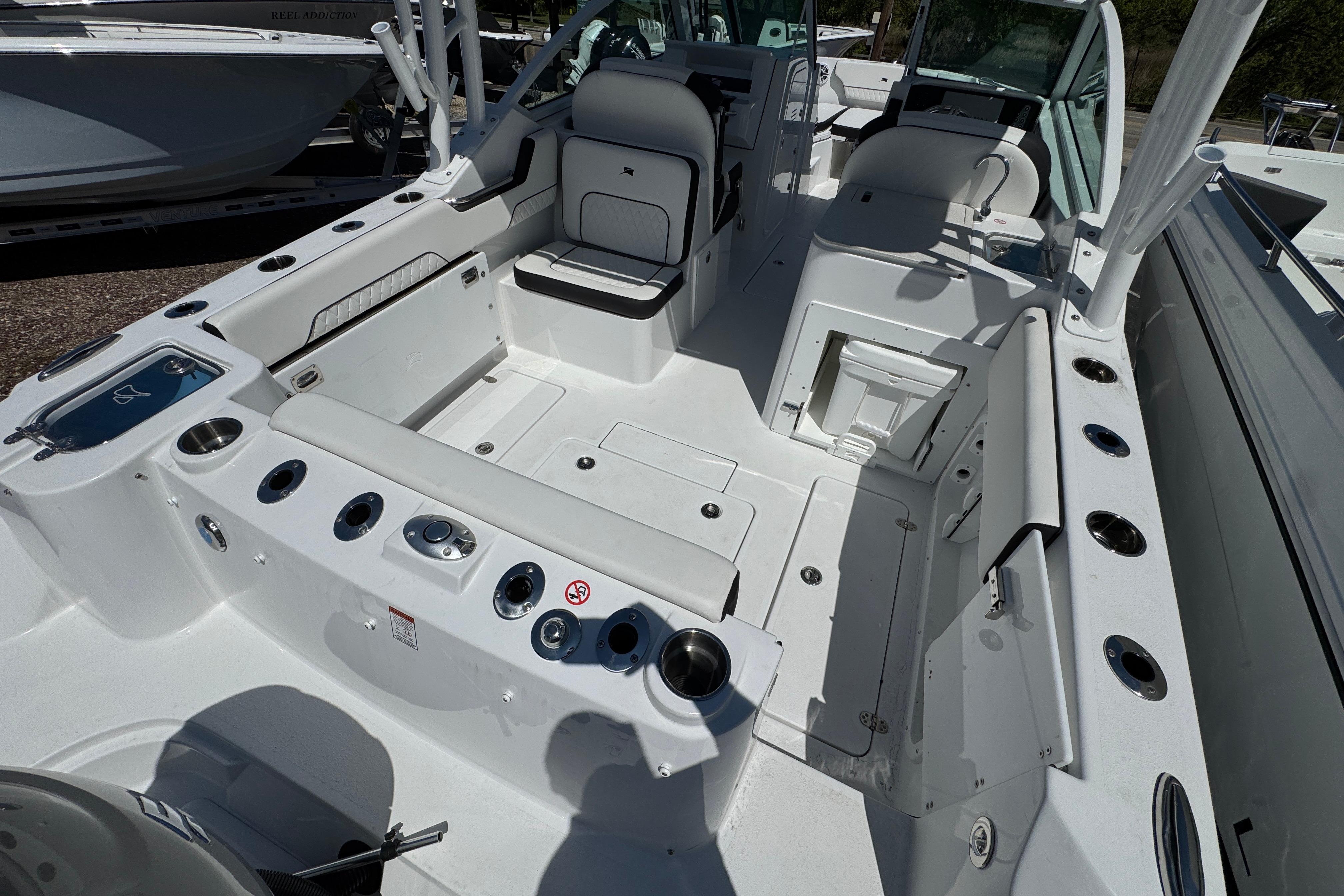 2026 Stingray 259 DC boat interior with seating, storage, and fishing rod holders.