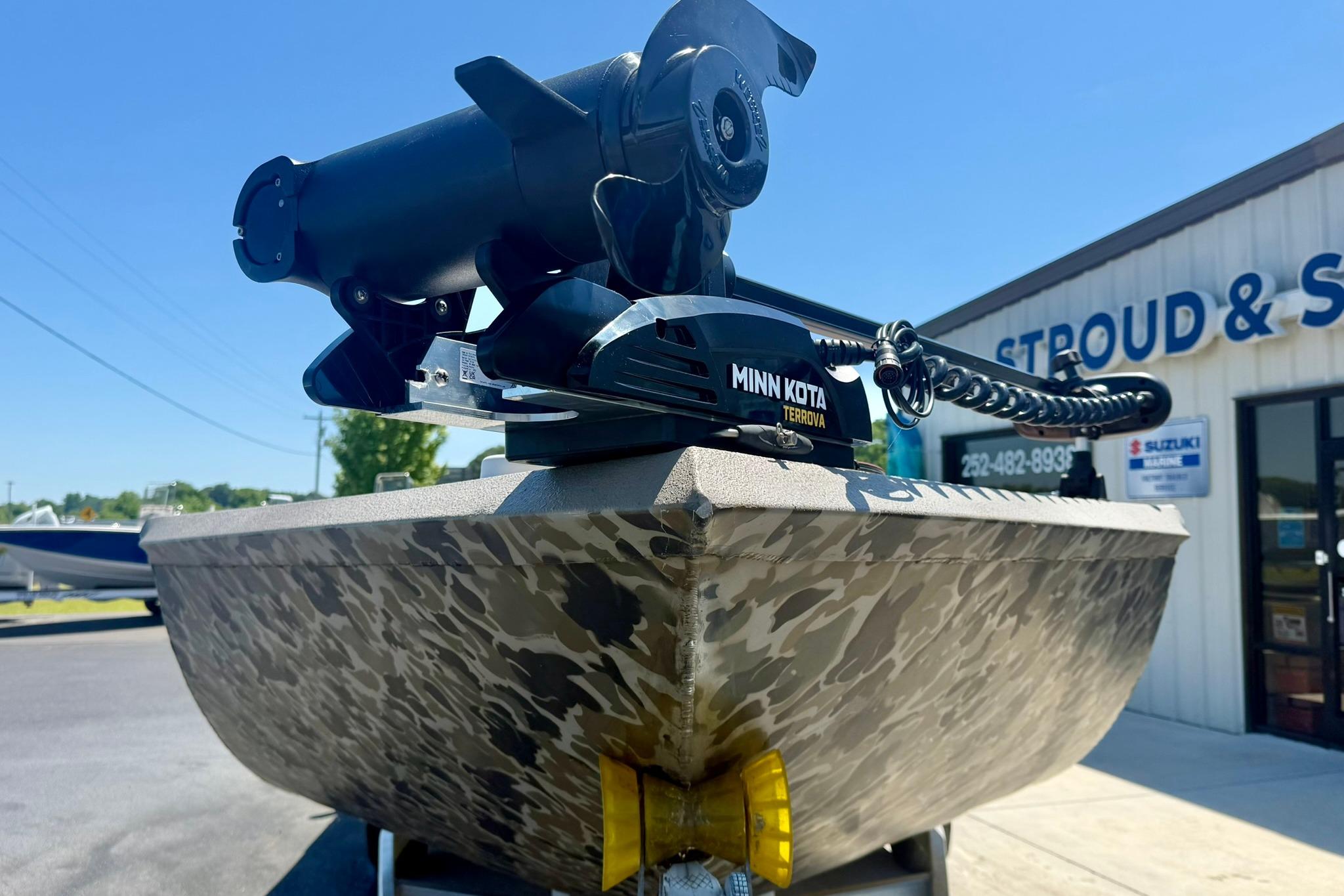 2019 Excel 230 Bay Pro boat with Minn Kota Terrova motor, parked outside dealership.