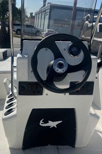 2025 Mako Pro Skiff 15 CC steering console with black wheel and control panel.