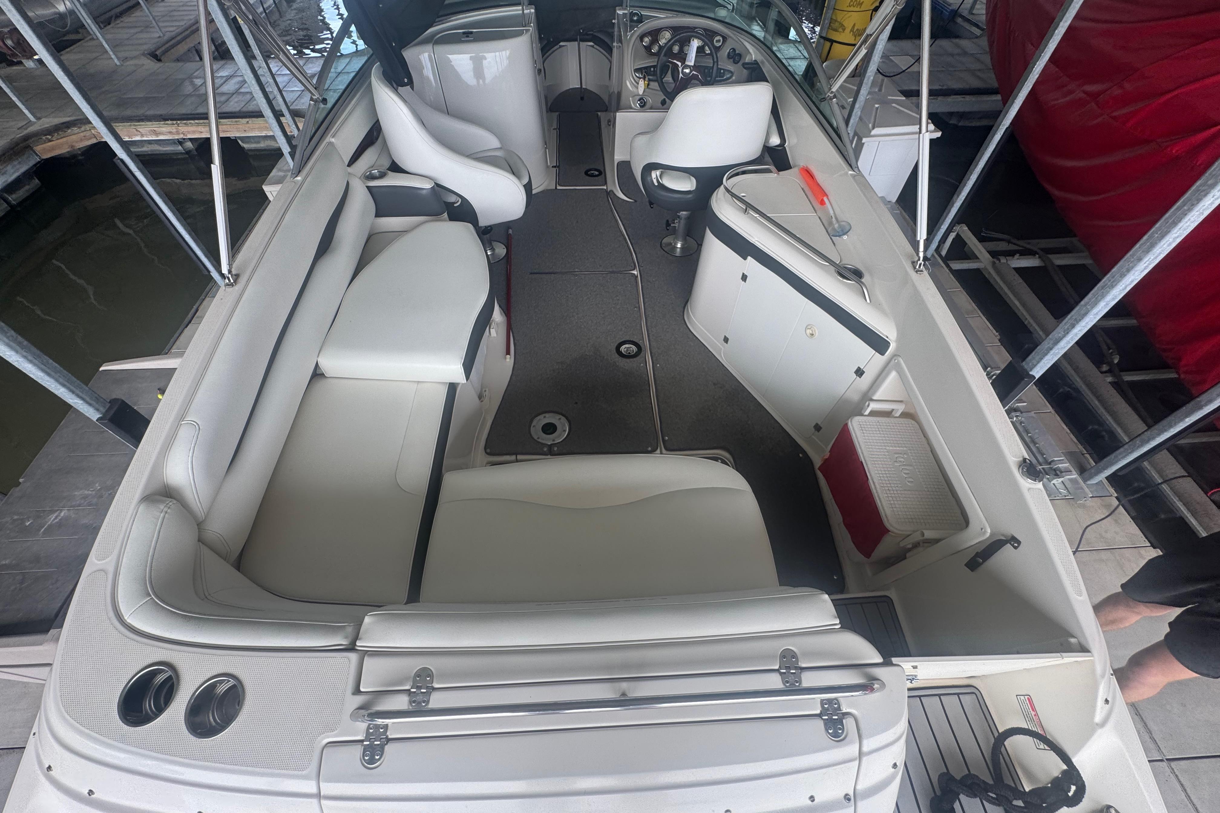 2005 Monterey 248LS Montura Bowrider interior with seating and helm, docked at marina.