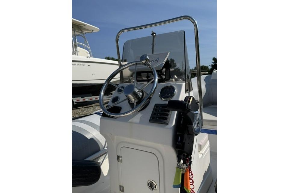 Steering console of 2022 North Atlantic Inflatables RIB420H boat with chrome details.