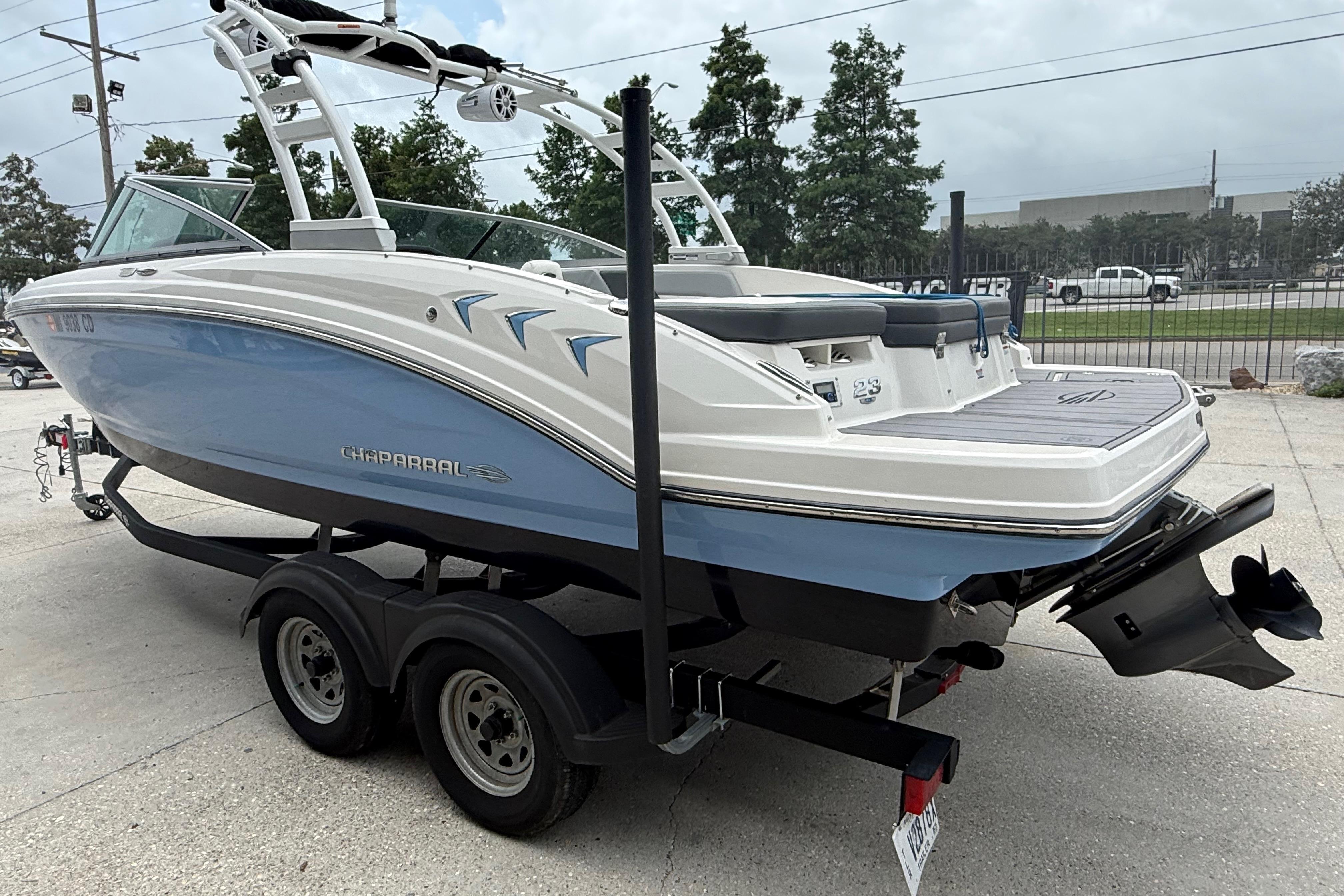 2023 Chaparral 230 SSi boat on trailer, featuring sleek design and modern amenities.