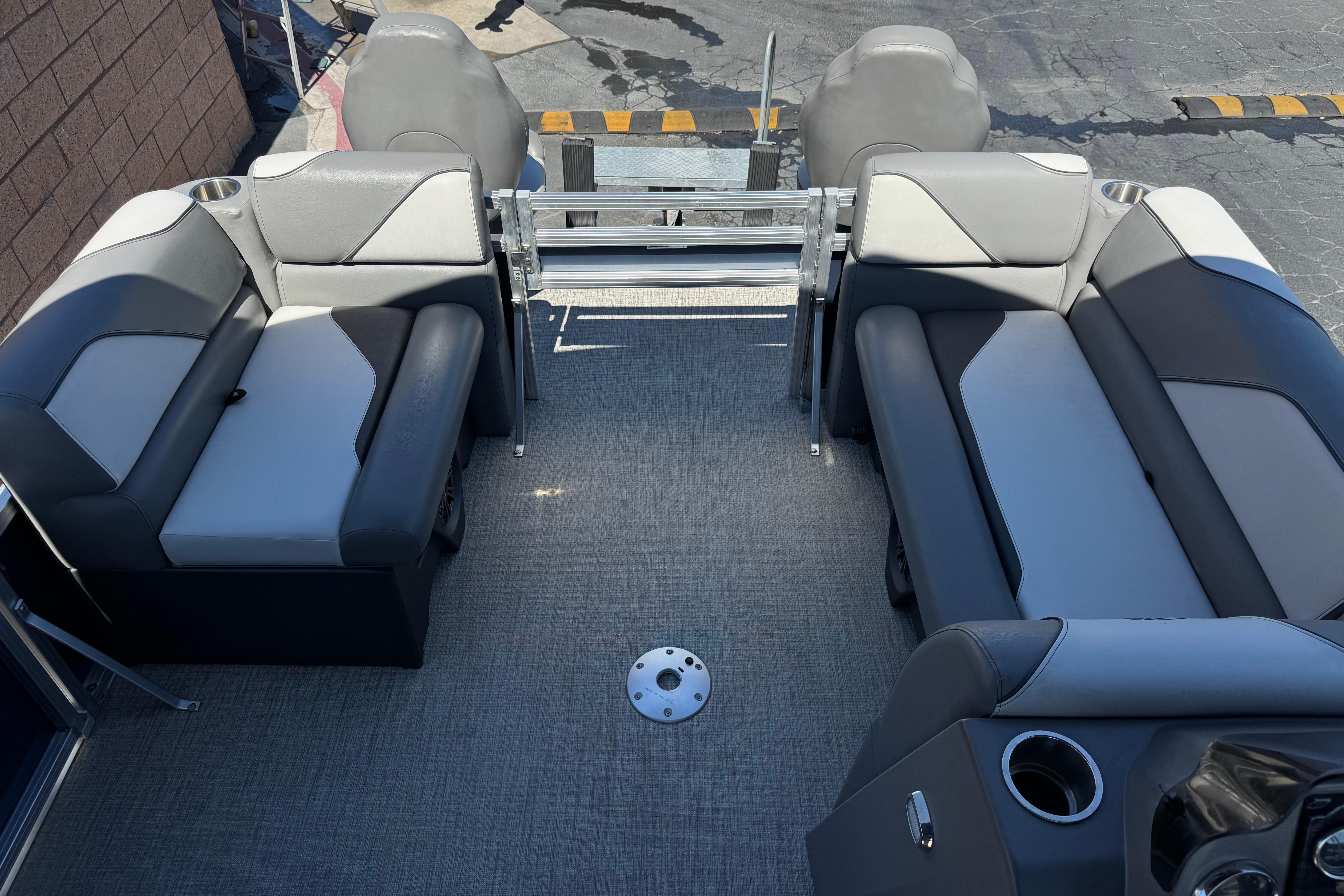 2023 Avalon Venture Fish N Cruise 20' interior with gray seating and cup holders.