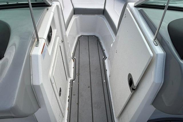 2021 Chaparral 21 SSi boat interior, featuring sleek gray flooring and white paneling.