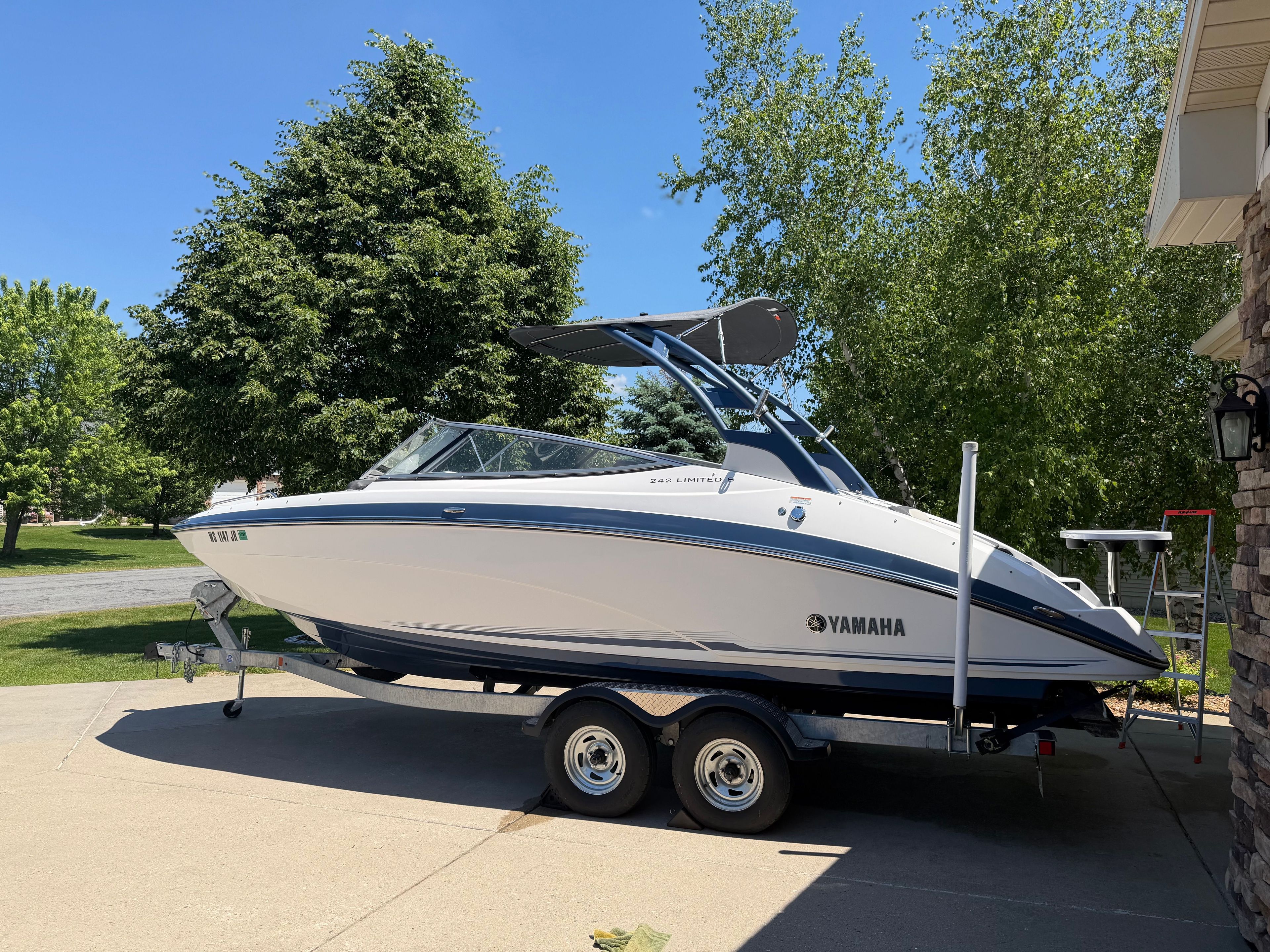 Yamaha 242 Limited S from 2018 parked on a trailer in a driveway.