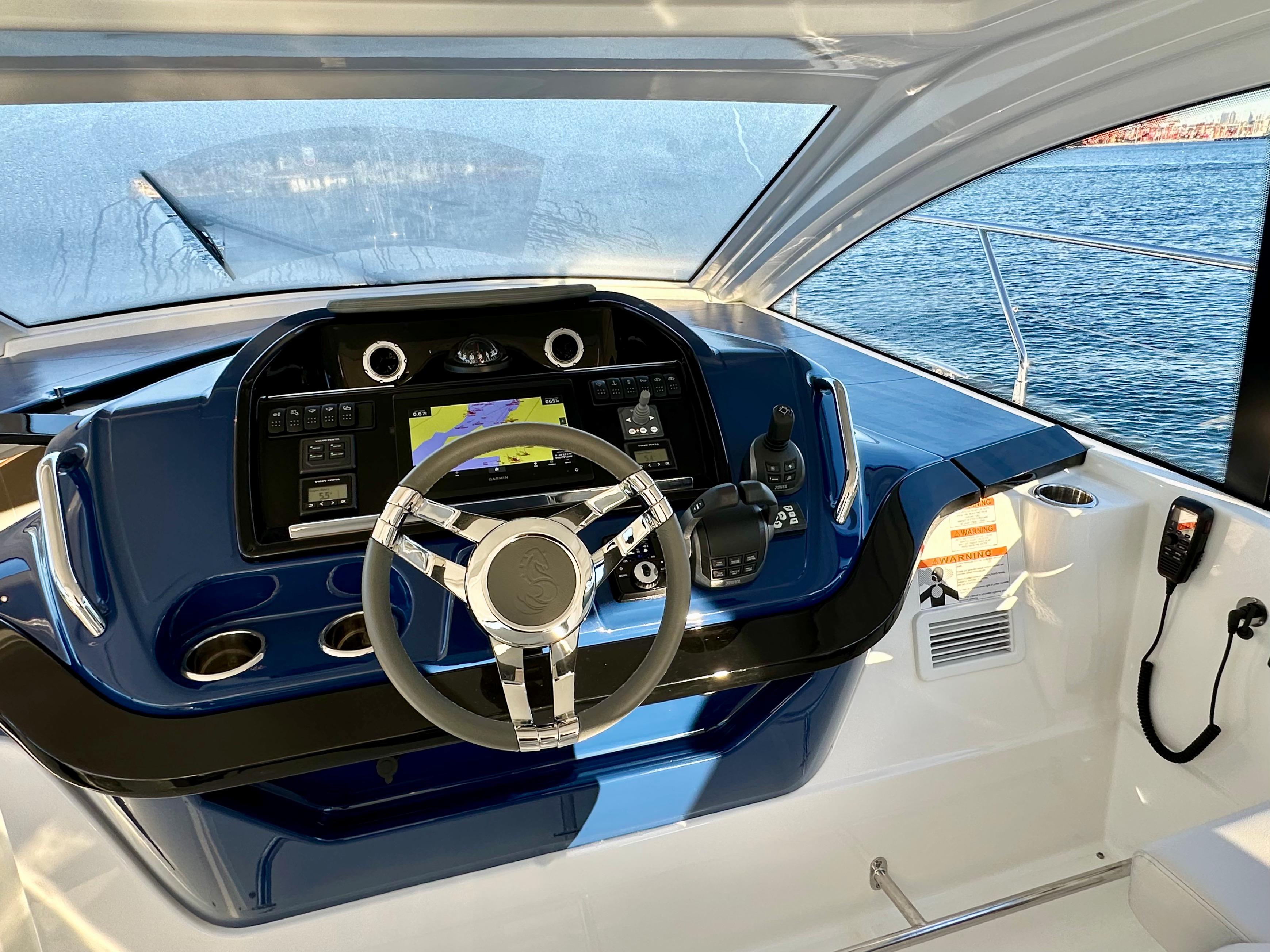 2024 Beneteau Gran Turismo 41 helm with modern navigation system and ocean view.