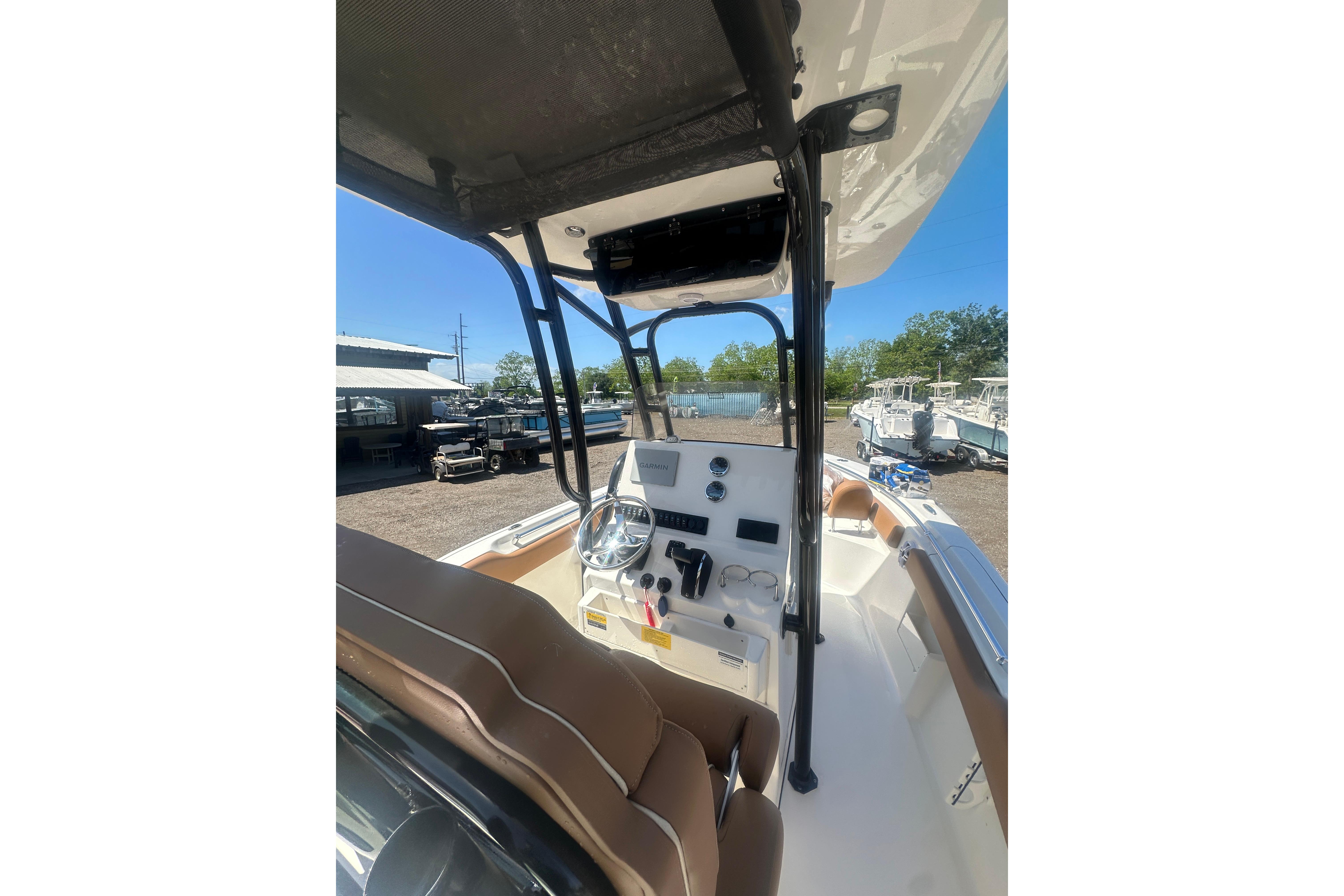 2026 Key West 239 FS boat interior with steering console and seating.