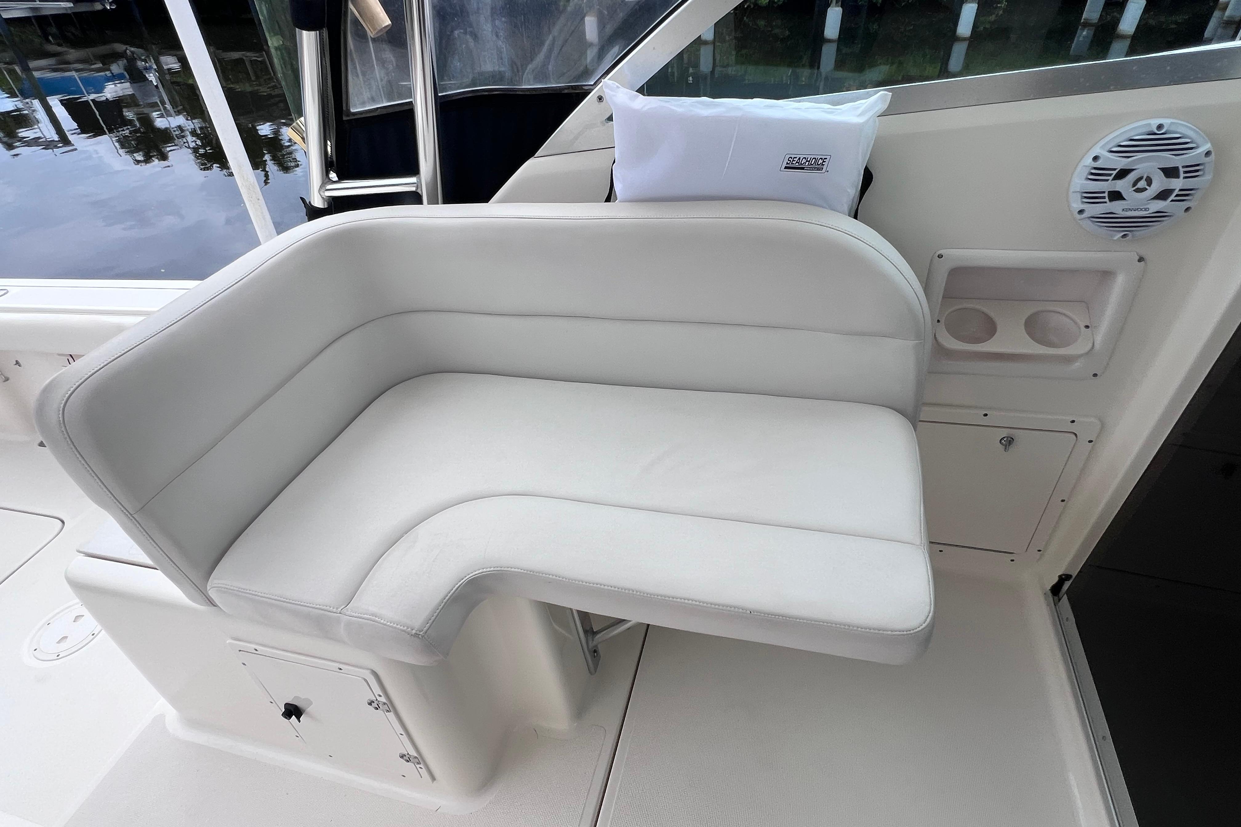 2005 Pursuit 3070 Offshore boat interior with white cushioned seating and cup holders.