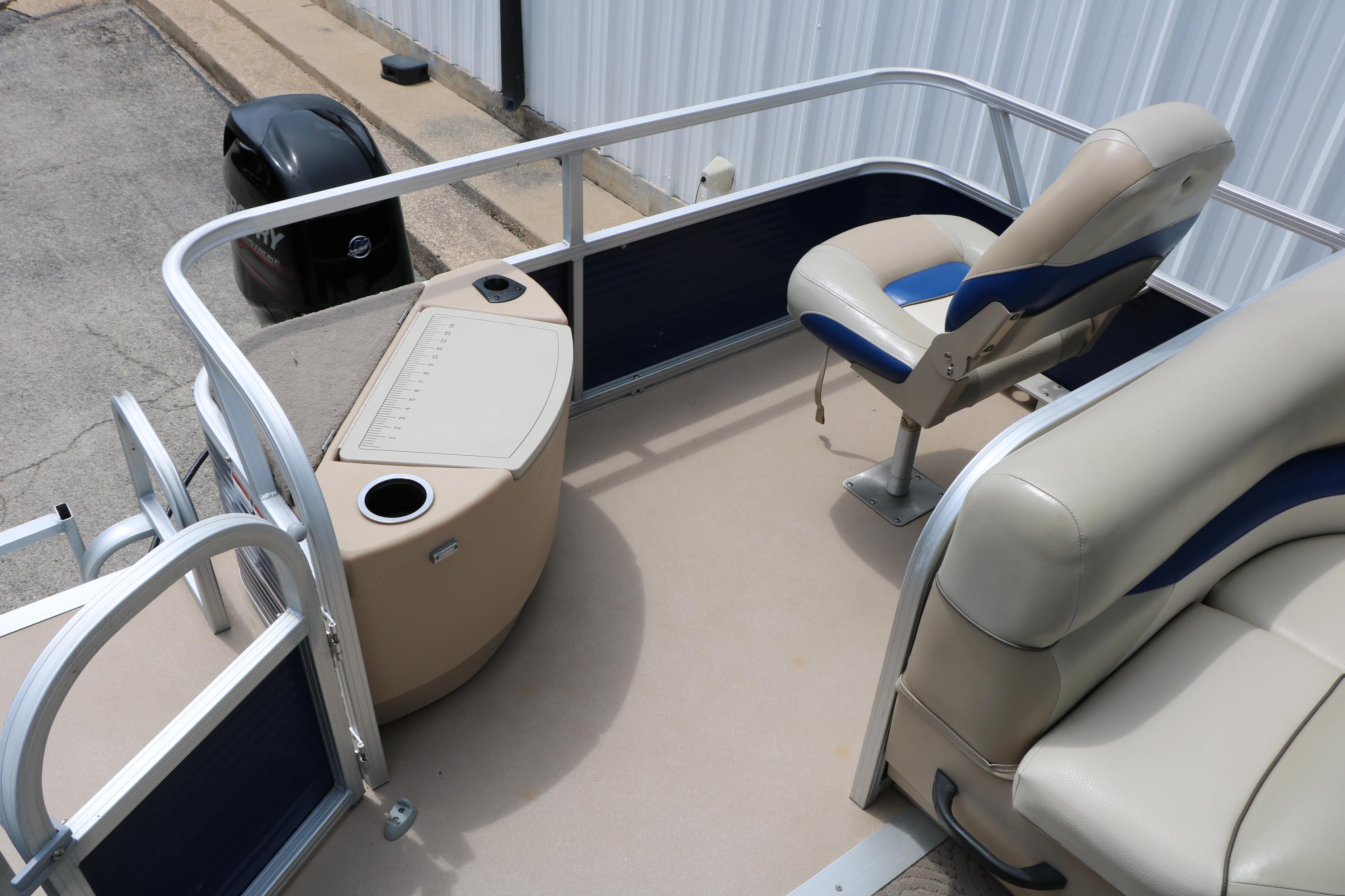 2013 Sun Tracker Fishin' Barge 20 DLX interior with seating and fishing station.