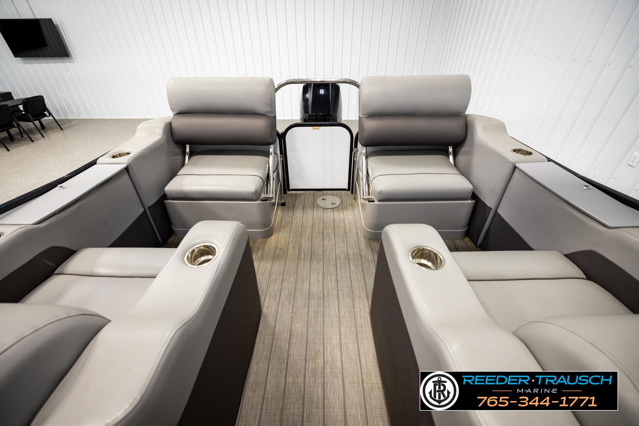 2019 Manitou Oasis SR VP pontoon boat interior with plush seating and cup holders.