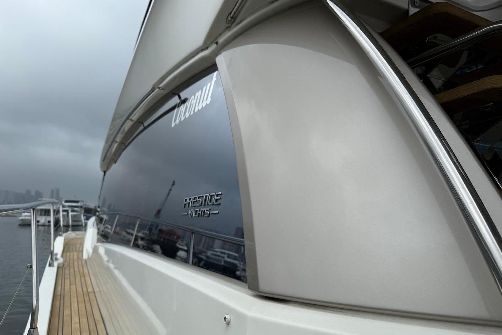 2019 Prestige 630 yacht docked, showcasing sleek design and branding.