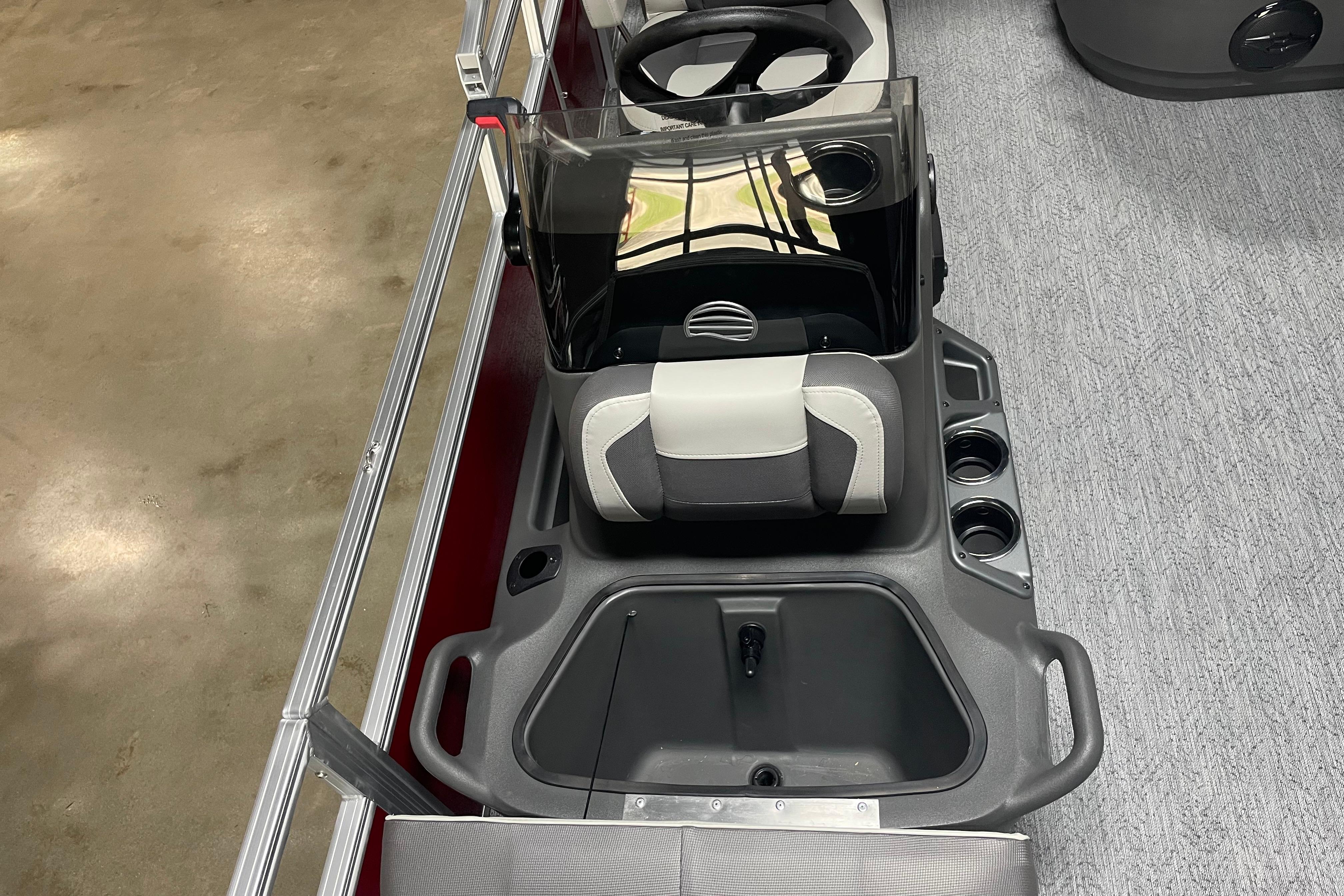 2026 Sun Tracker Bass Buggy 18 DLX boat console with steering wheel and seating.