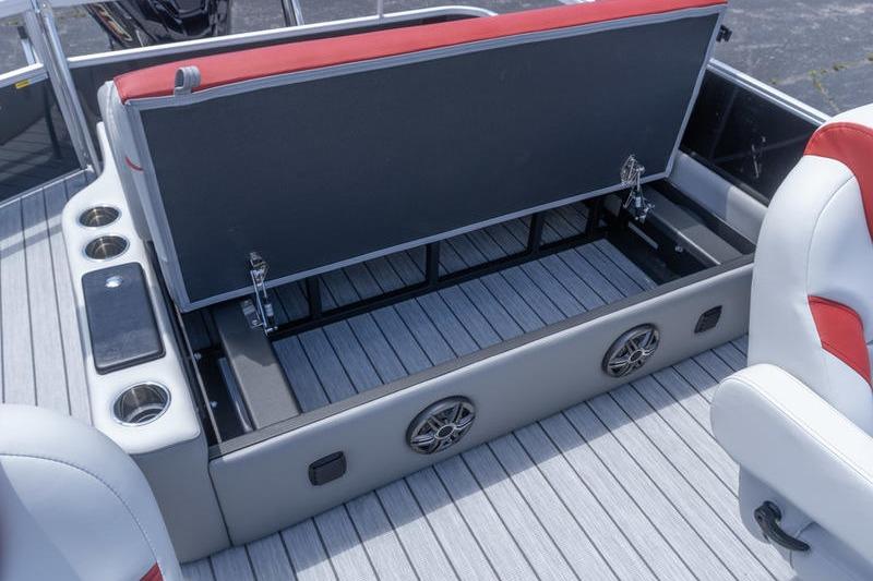 2026 SunCatcher Select 322SL boat interior with open storage compartment and cup holders.