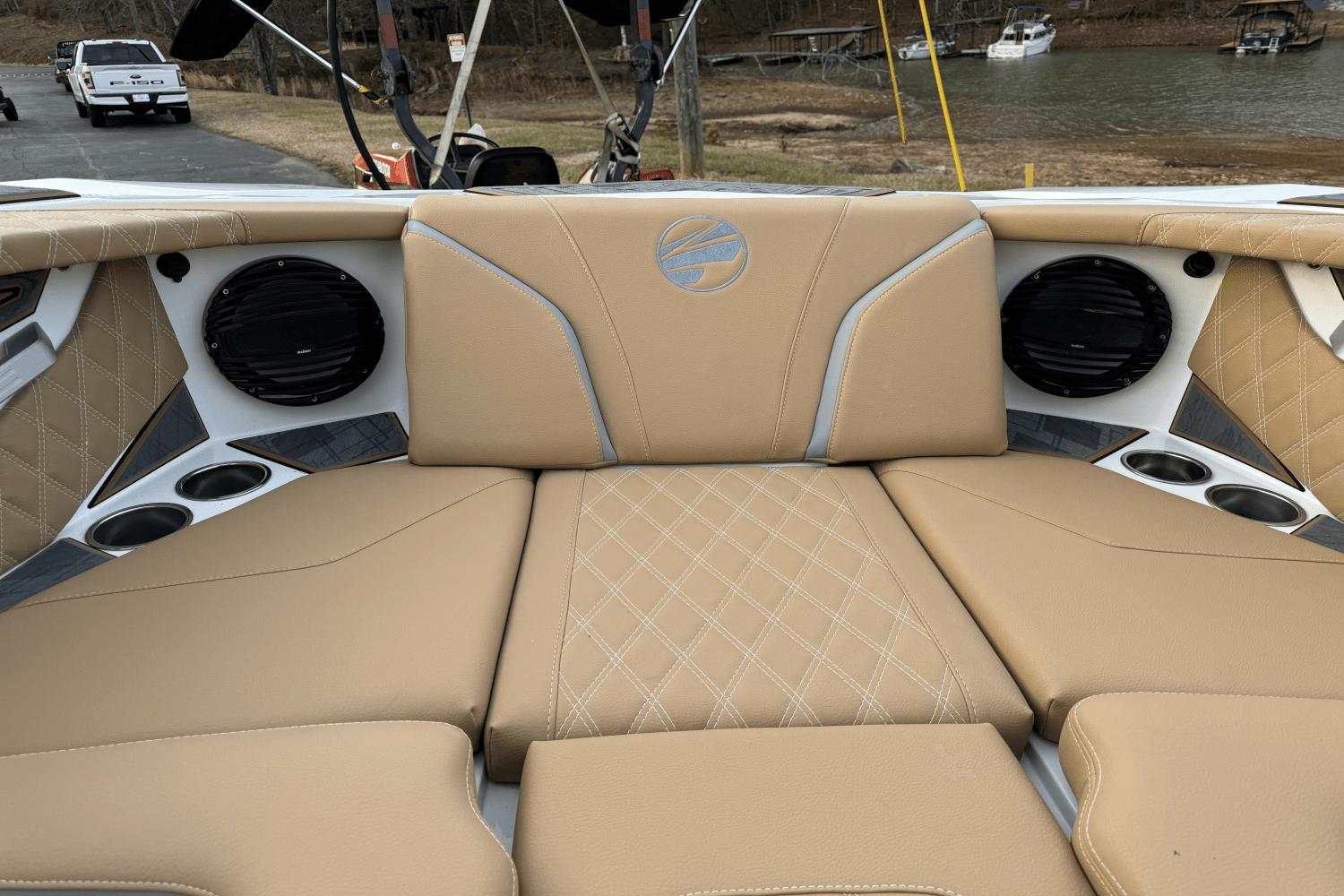 2024 Tigé RZX22 boat interior with tan leather seats and built-in speakers.