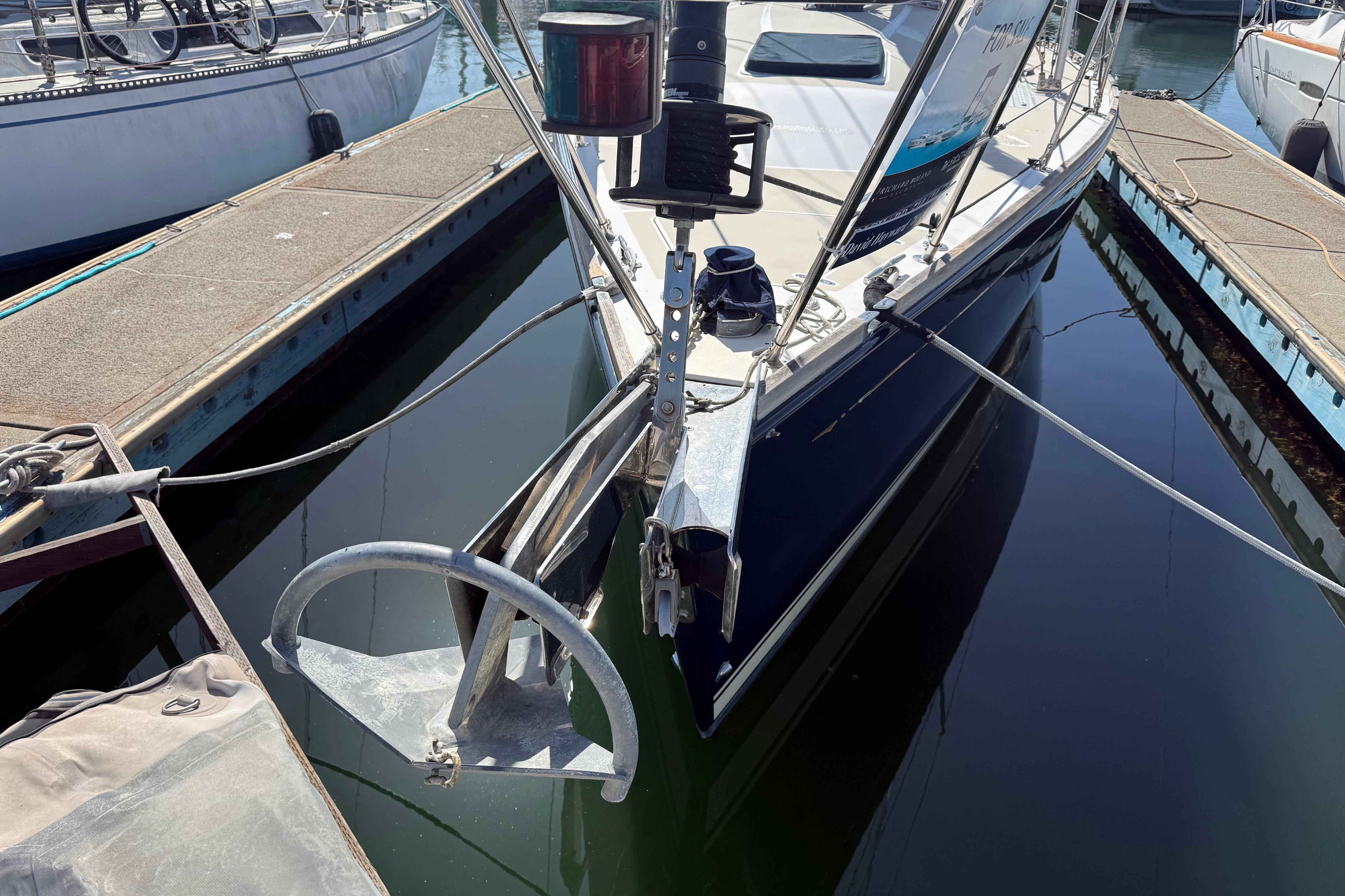 2004 Sabre 386 sailboat docked, featuring a prominent anchor and sleek design.